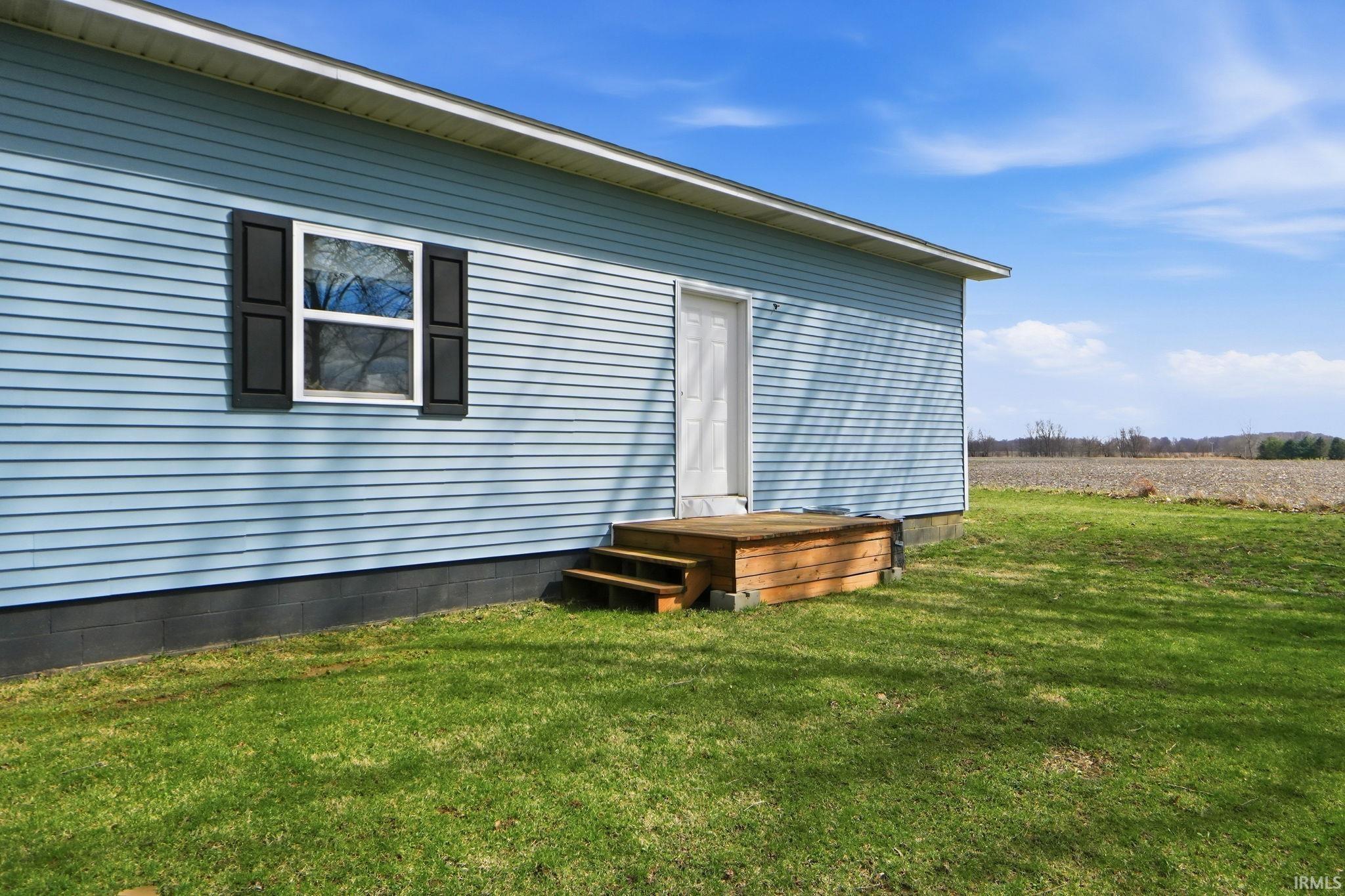 Light blue vinyl siding exterior with white trim