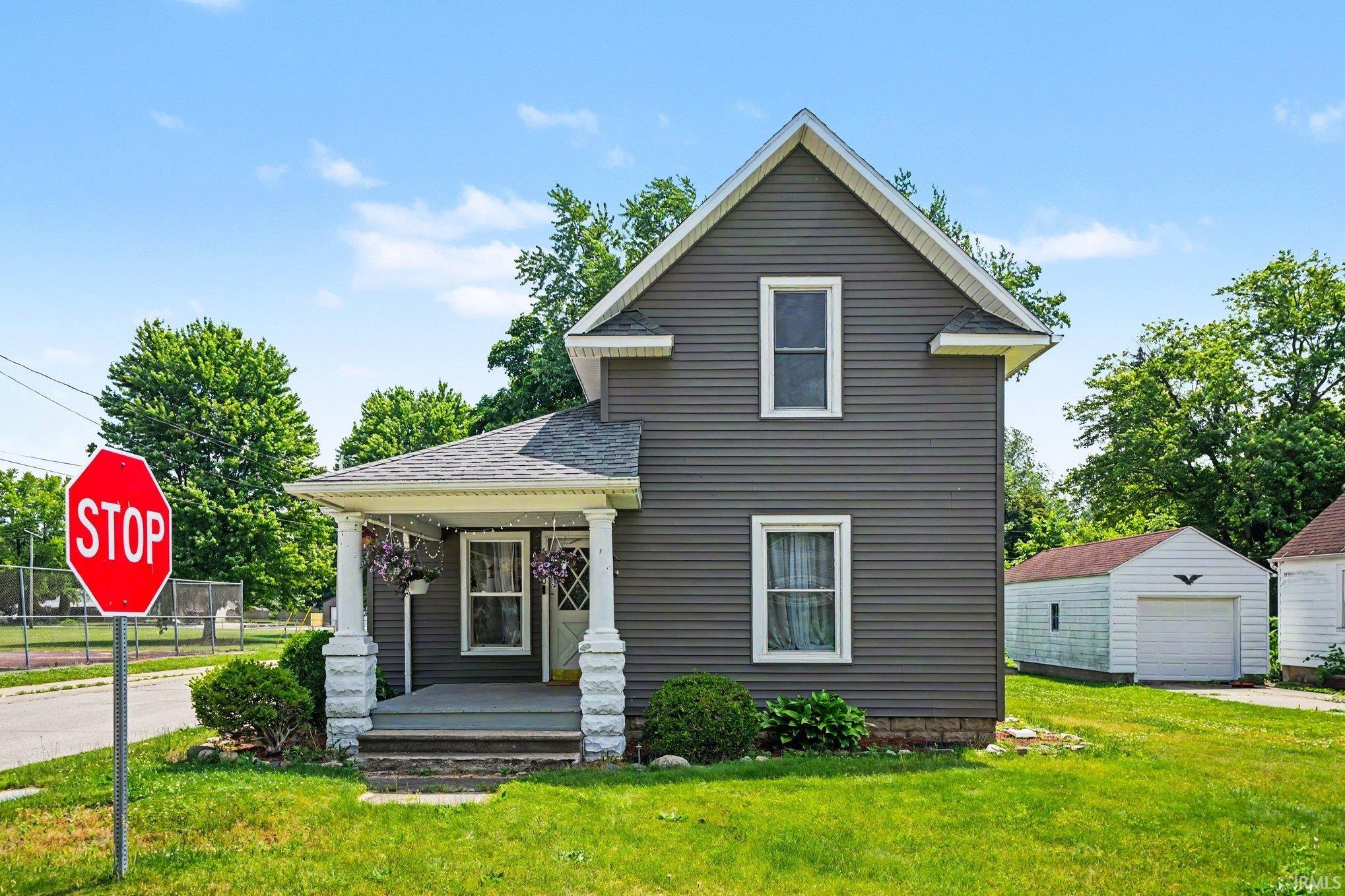 Two-story residence featuring gray siding and white trim