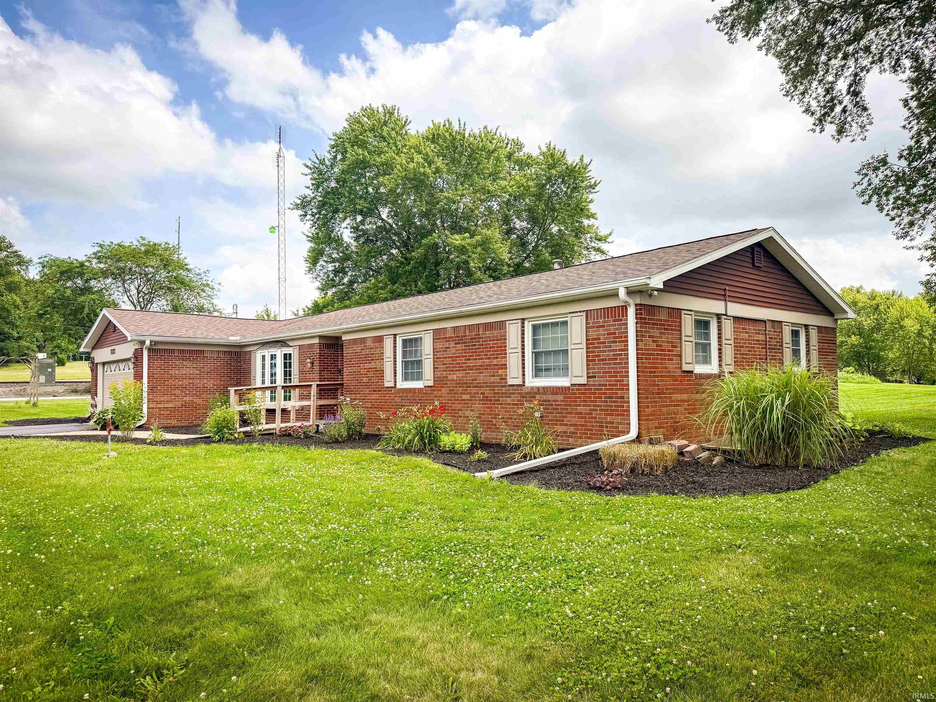 Brick exterior with gabled roofline and contrasting siding