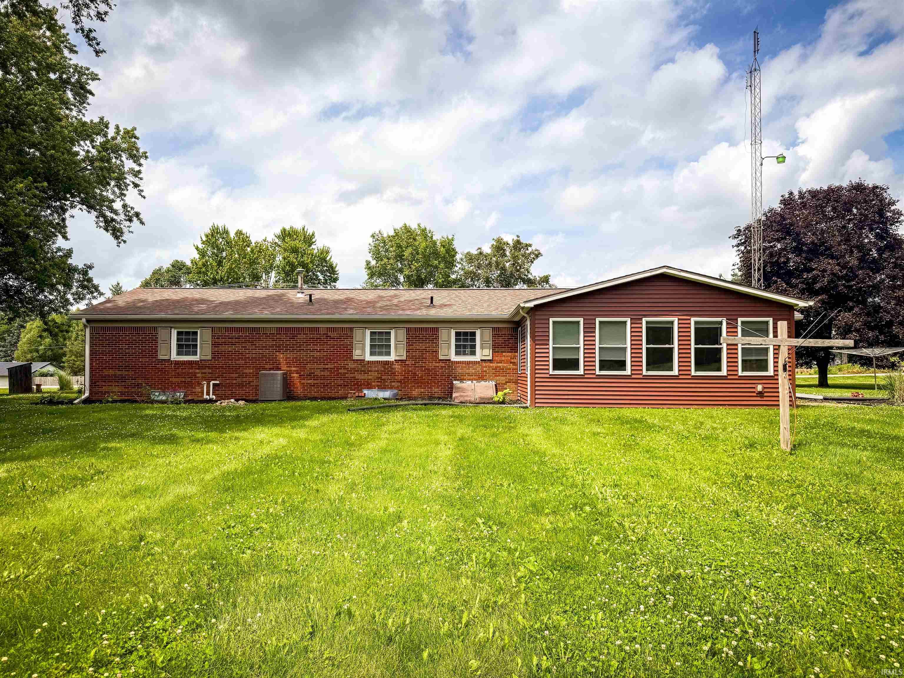 Expansive green lawn bordering the rear exterior of the property