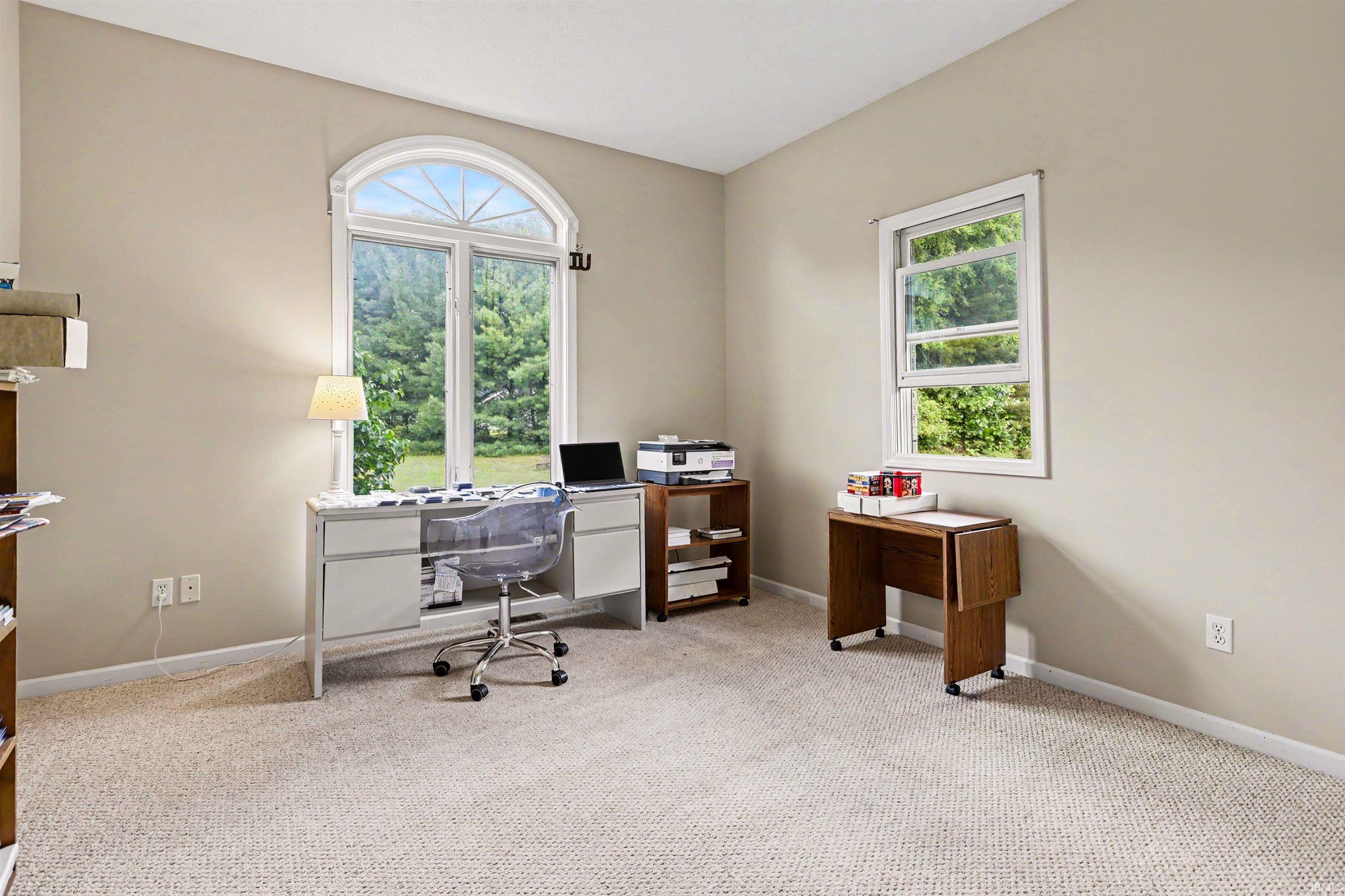 Warm neutral wall tones with plush carpeting throughout