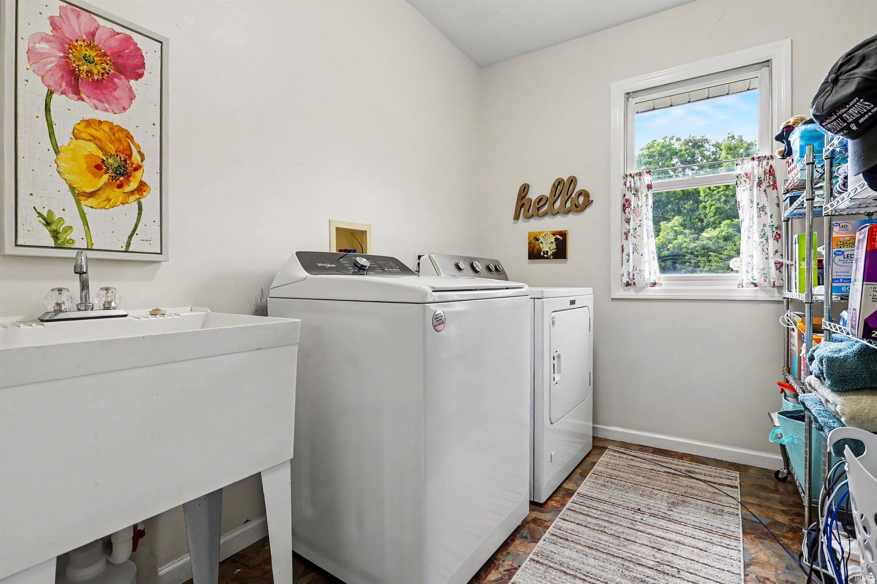 Utility room with a white utility sink, chrome faucet, and white walls