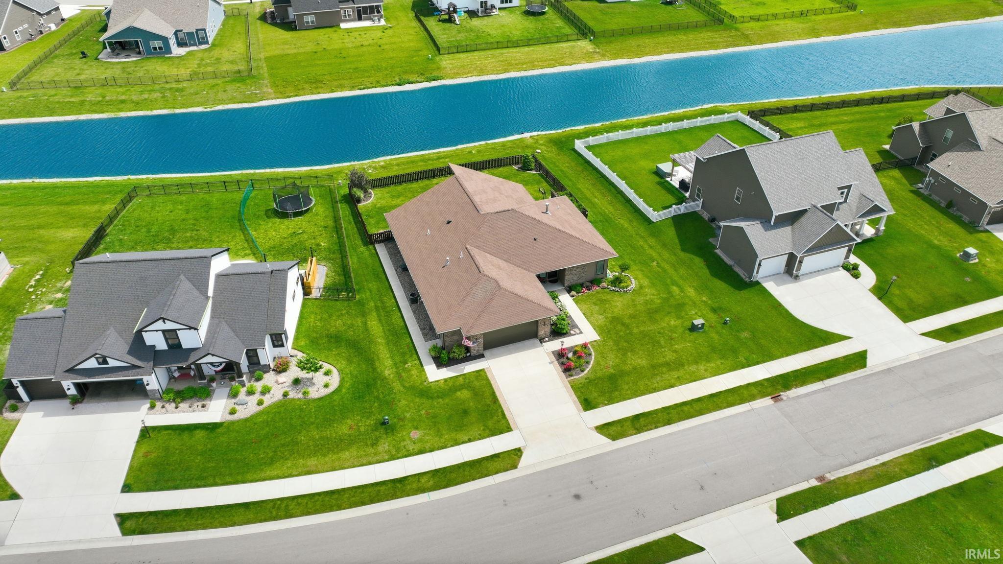 Aerial perspective showcasing a residential neighborhood with a prominent canal