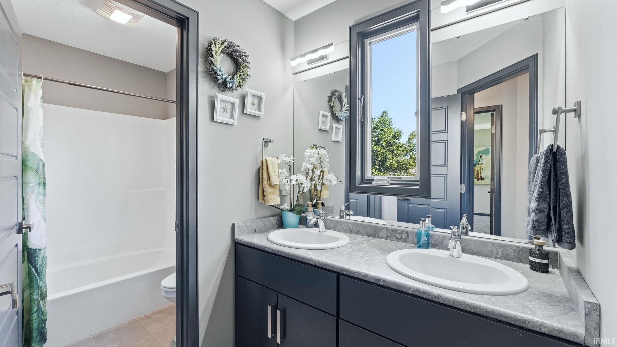 Double vanity with undermount sinks and gray countertops