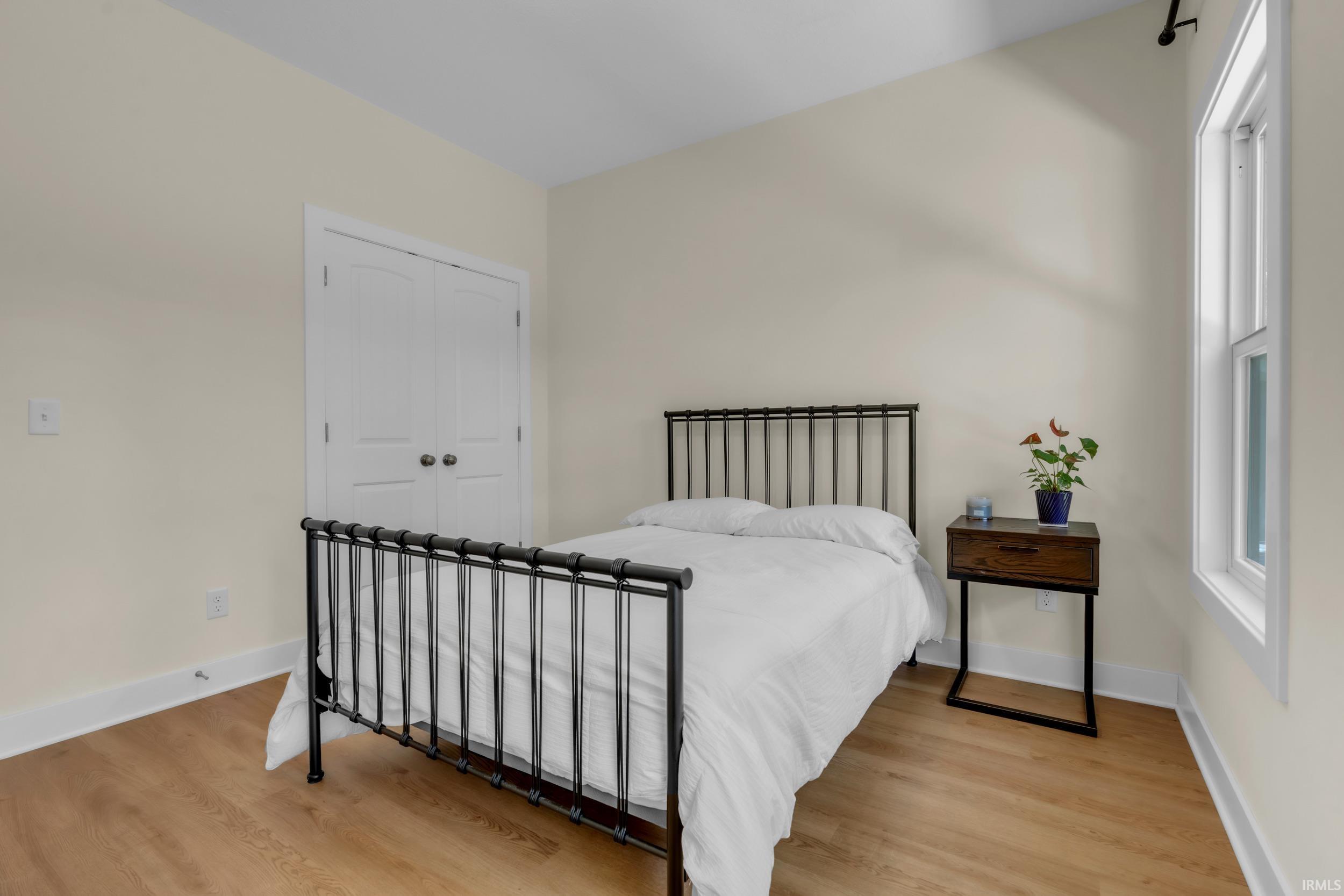 Bright room featuring wood-finish flooring and white baseboards