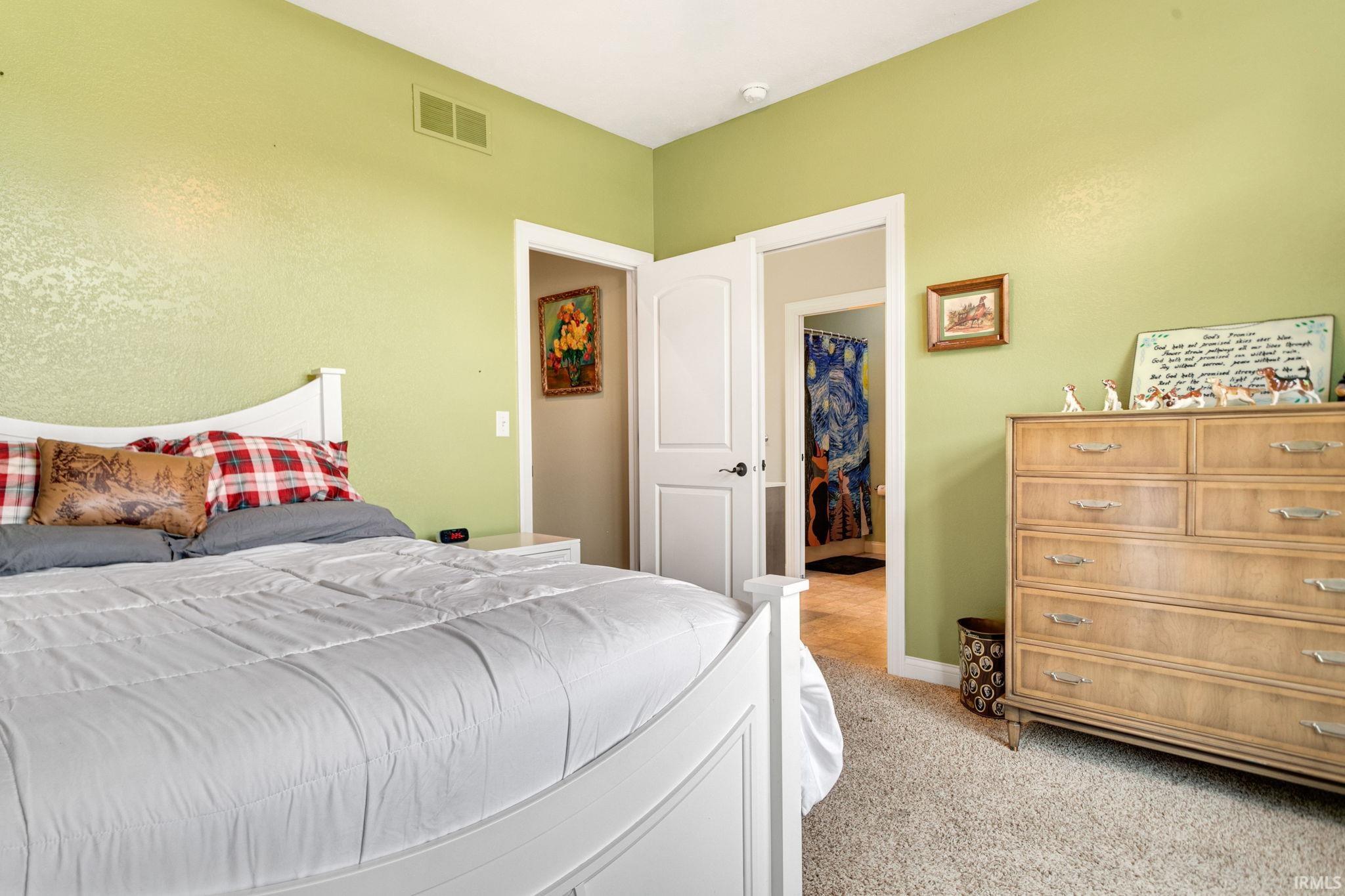 Carpeted room with light green walls