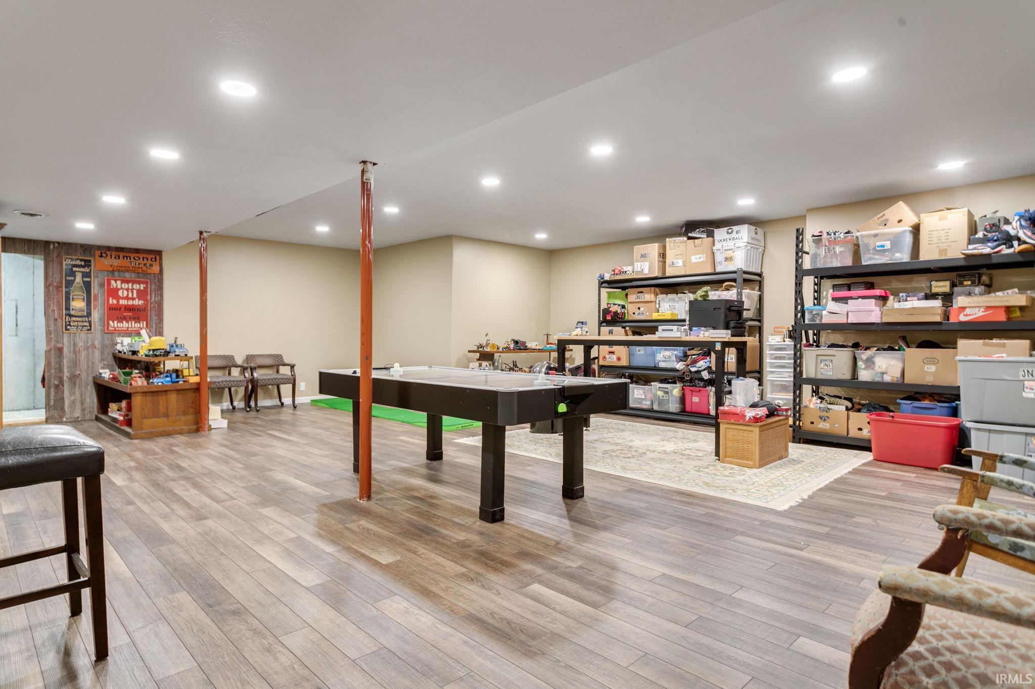 Spacious lower-level area featuring wood-finish flooring, recessed lighting, and neutral wall tones
