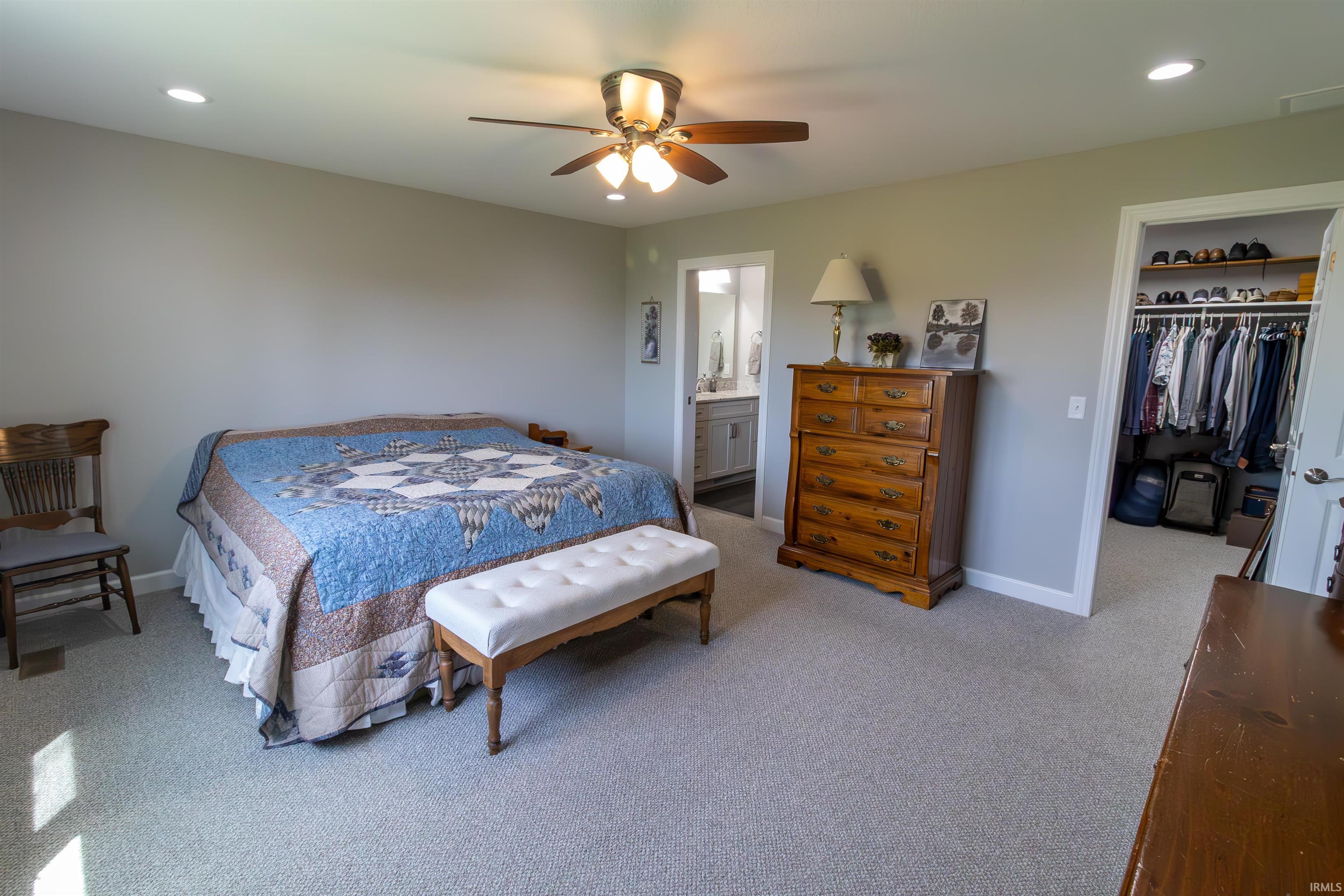 Spacious room featuring neutral wall tones, recessed lighting, and a ceiling fan