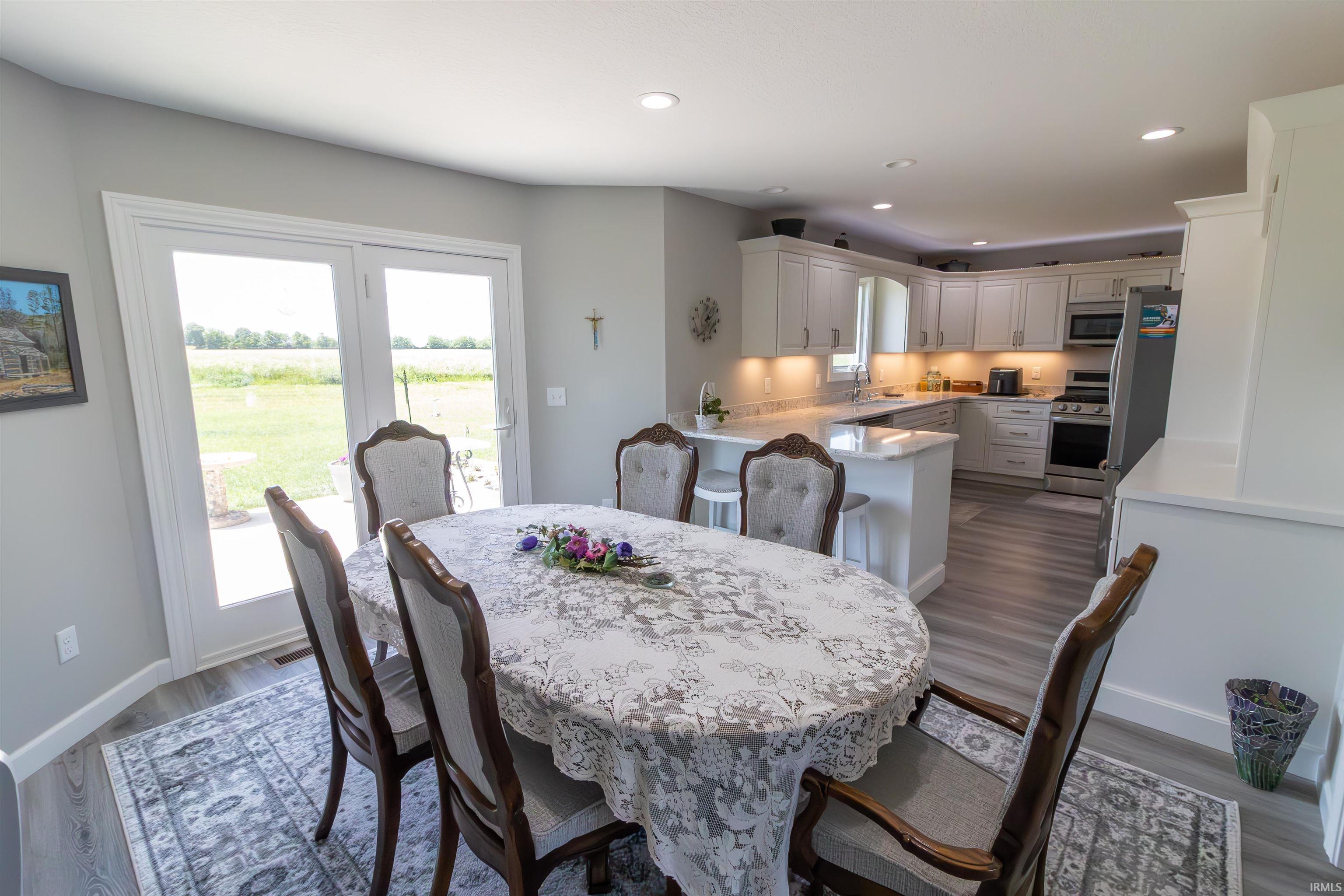 Kitchen and dining area featuring light wood-finish flooring