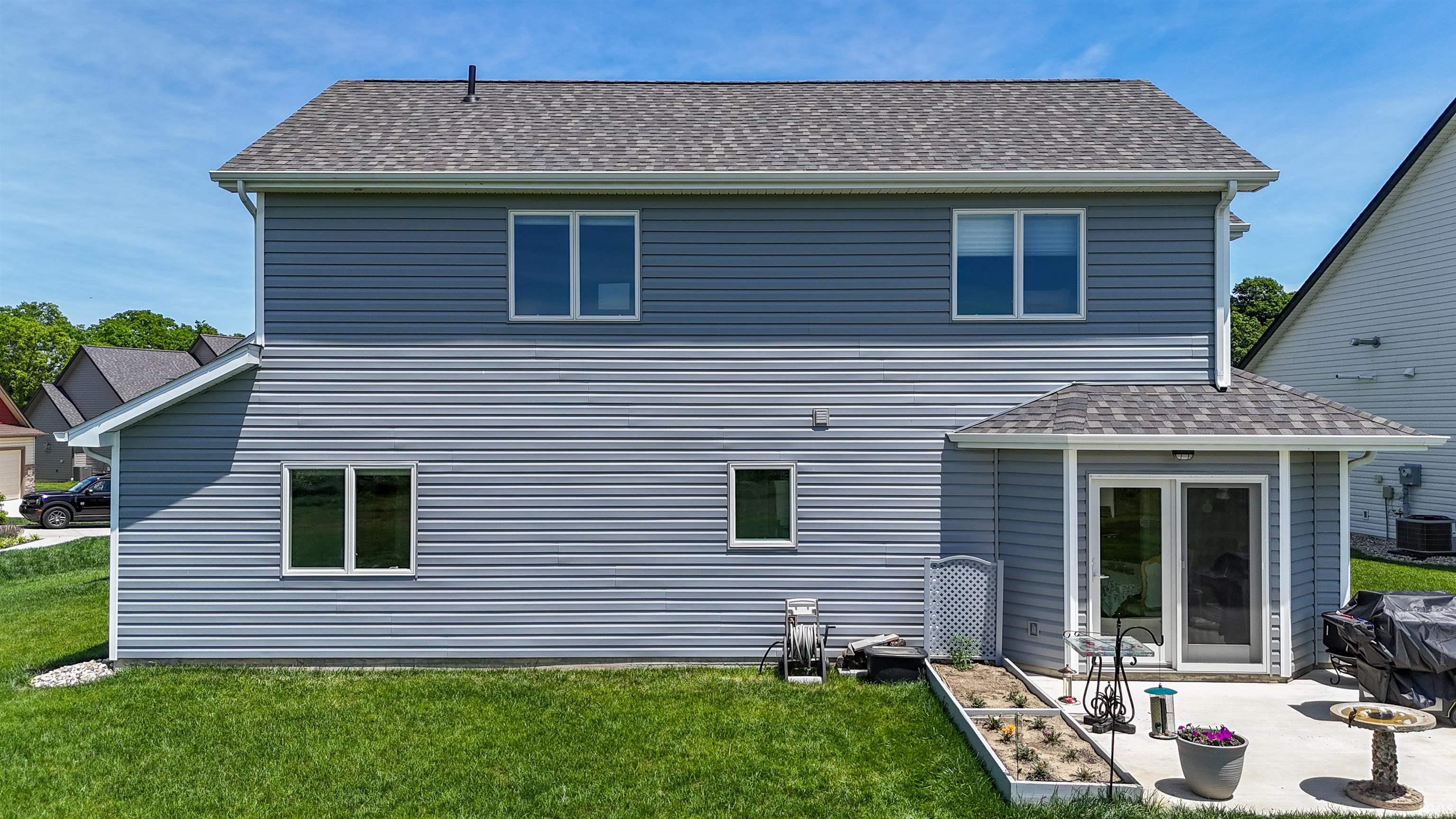 Two-story gray siding exterior with white trim