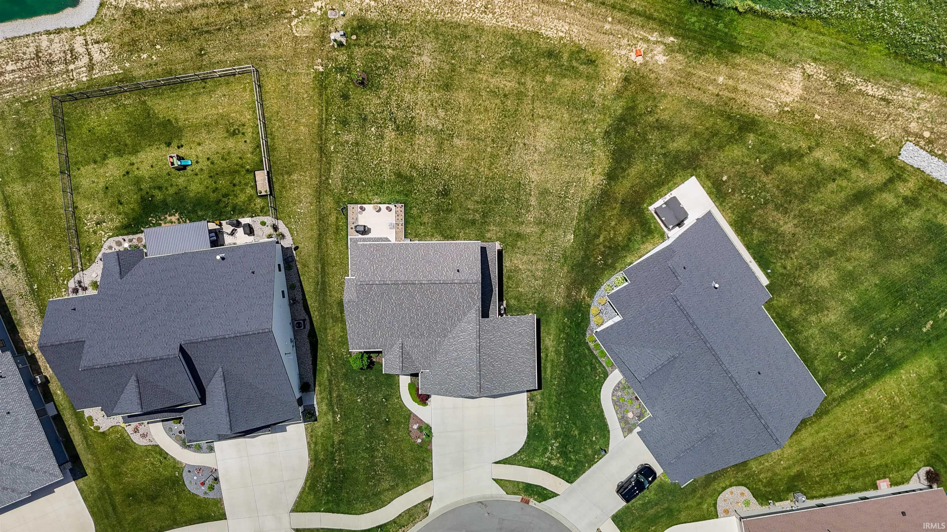 Aerial view showcasing a cul-de-sac with three properties