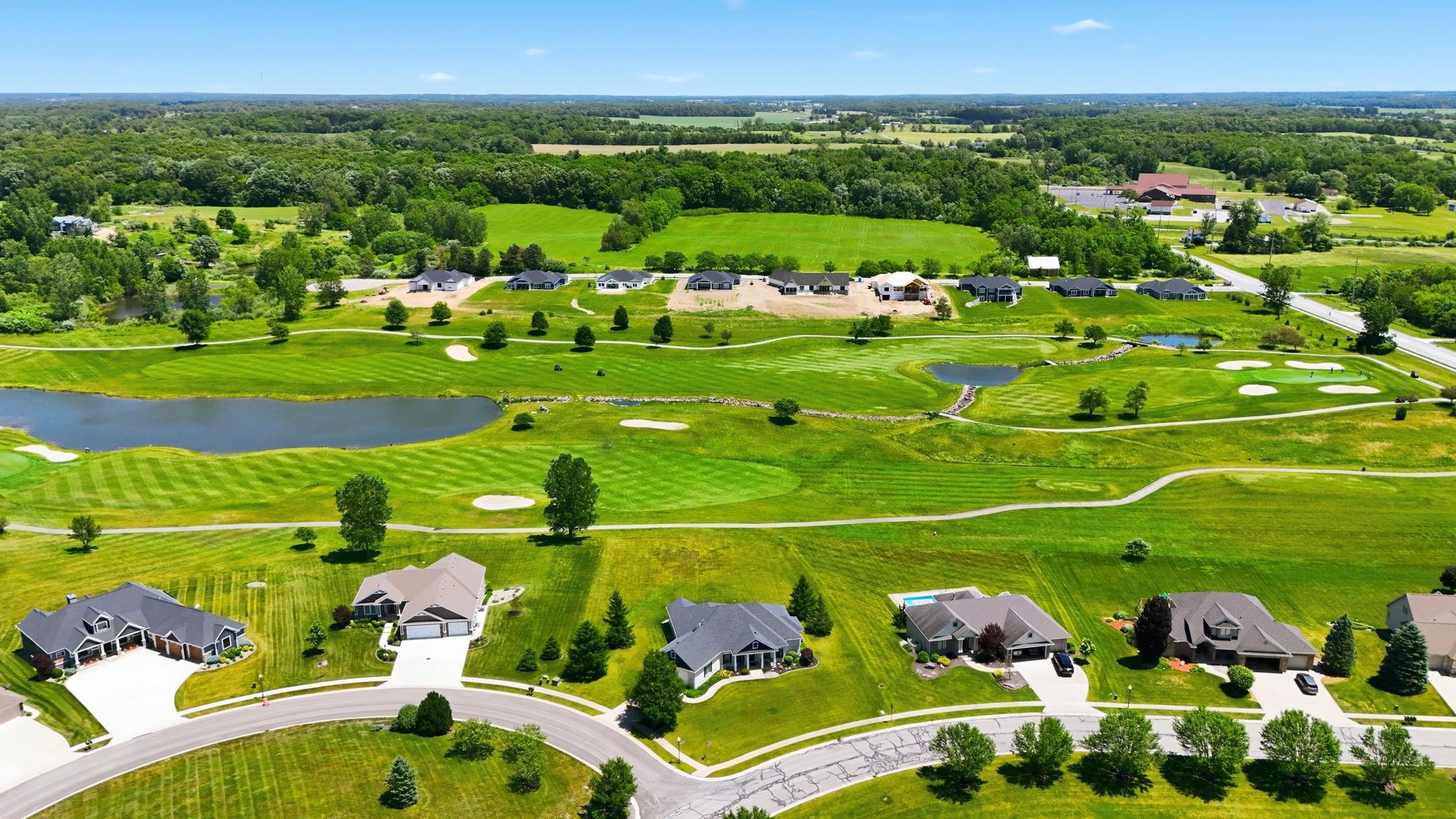 Aerial perspective showcasing a residential community amidst a golf course