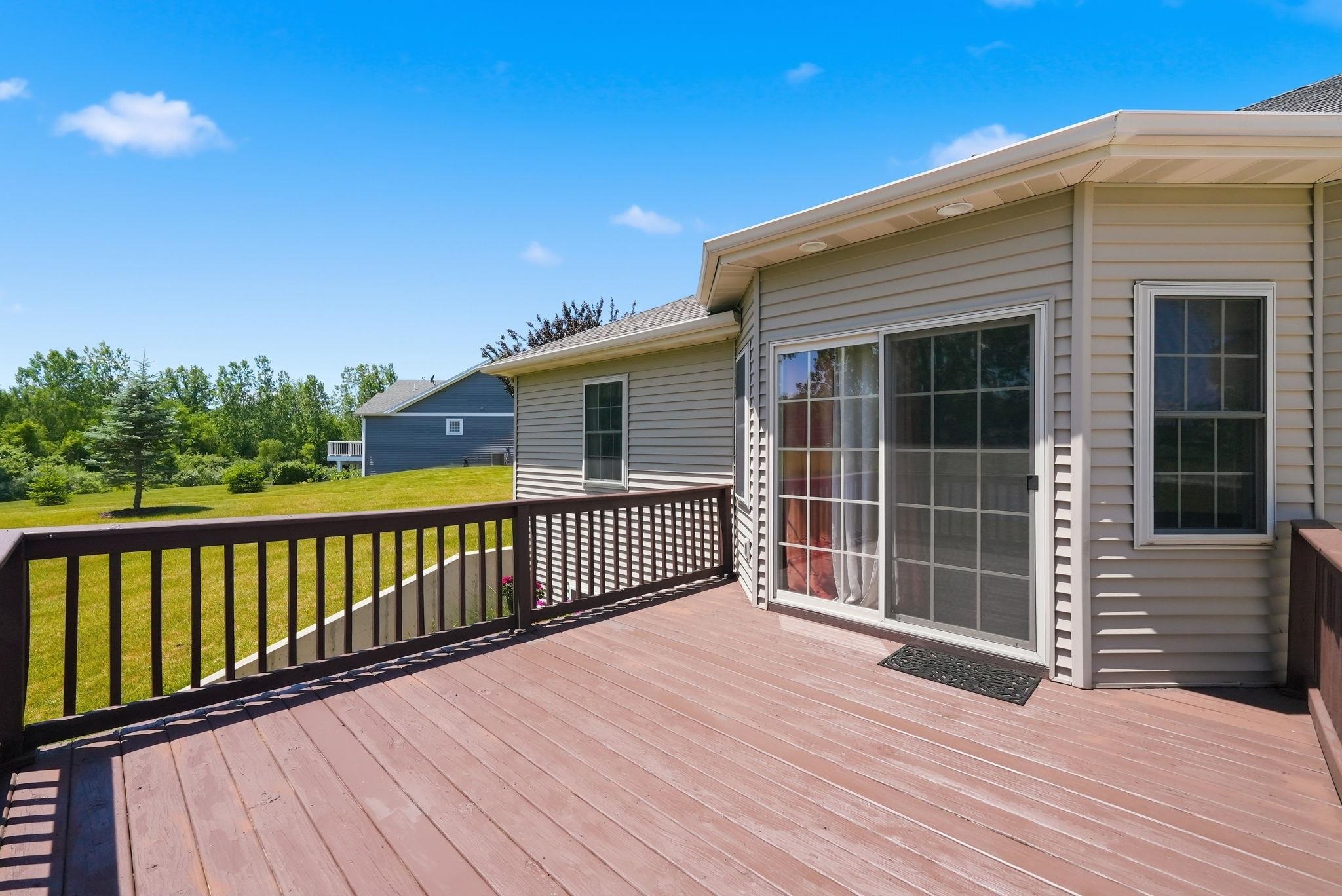 Expansive wood-finish deck with dark wood railing