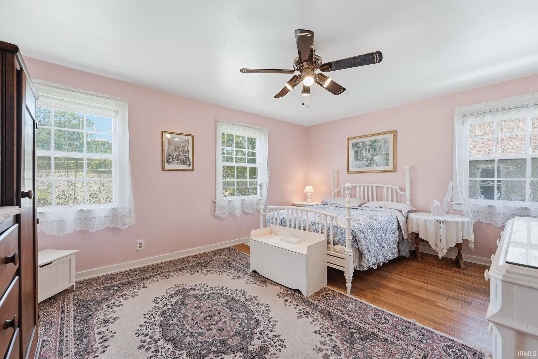Hardwood flooring complemented by light pink walls