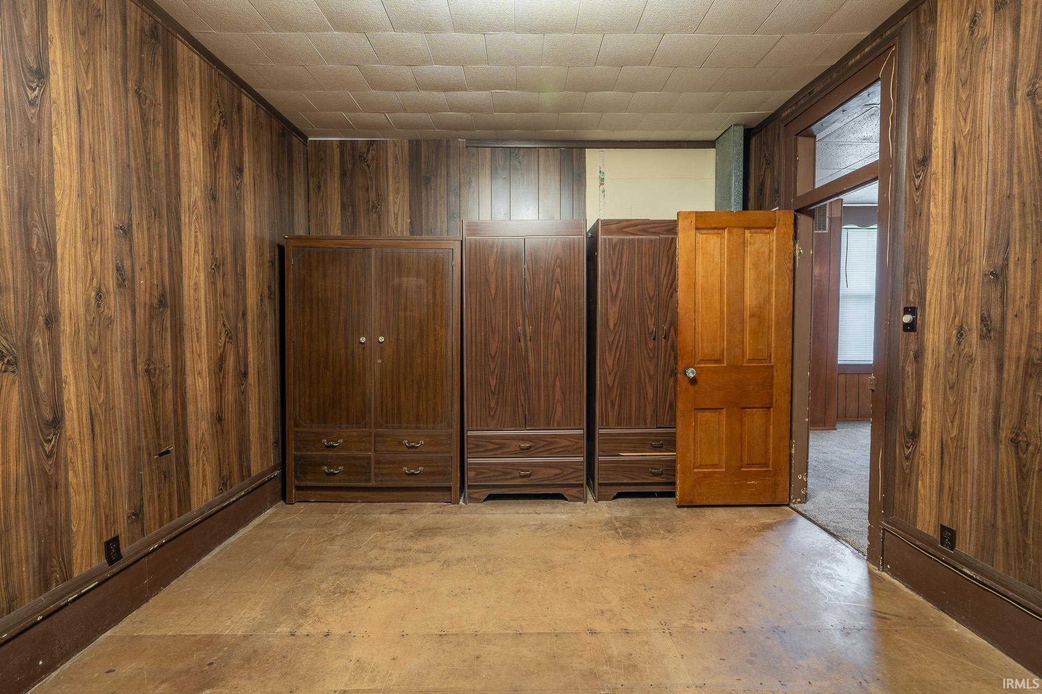 Wood-finish wall paneling throughout, complemented by a textured ceiling