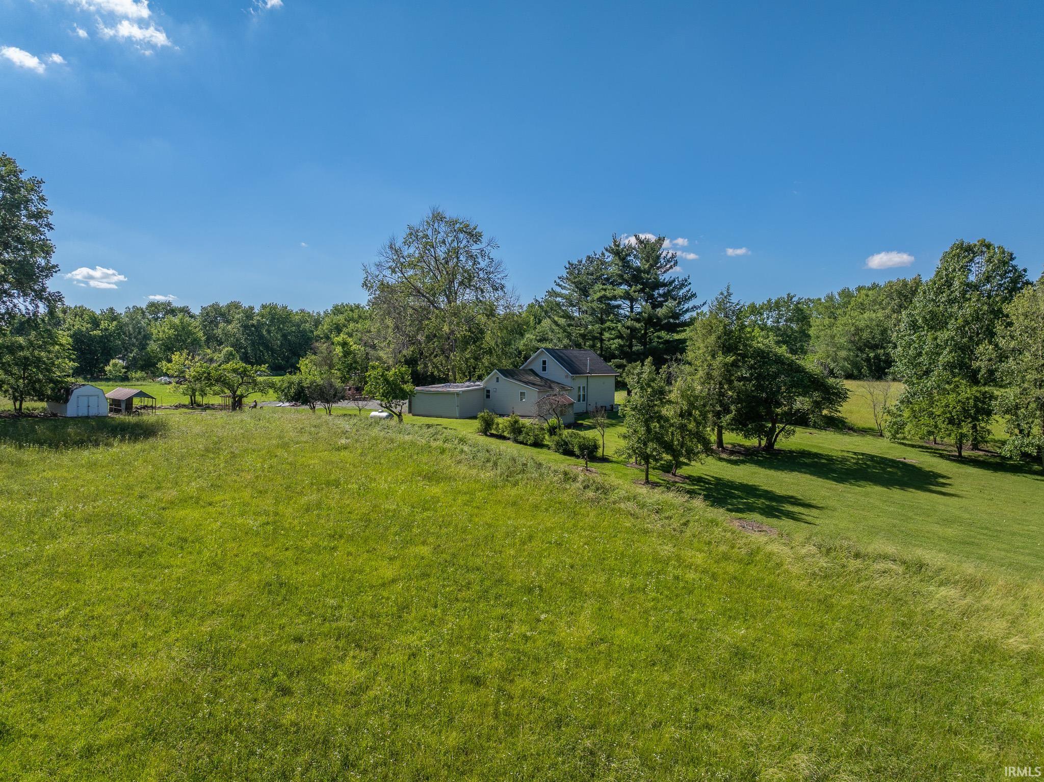 Expansive green acreage with mature trees