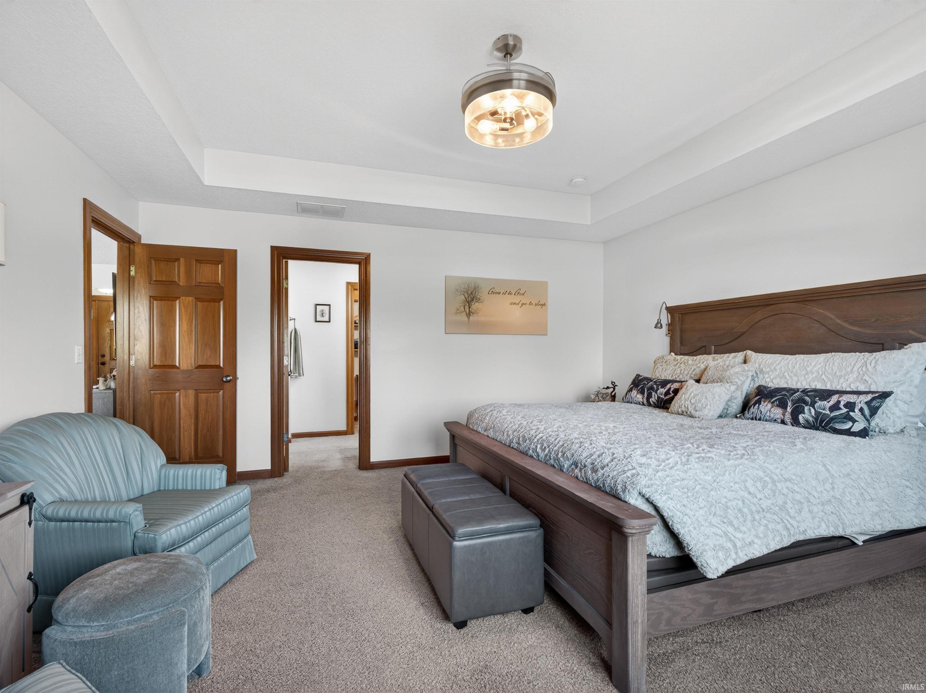 Spacious bedroom featuring a tray ceiling, ACCENT lighting, and a contemporary ceiling fixture FAN remote