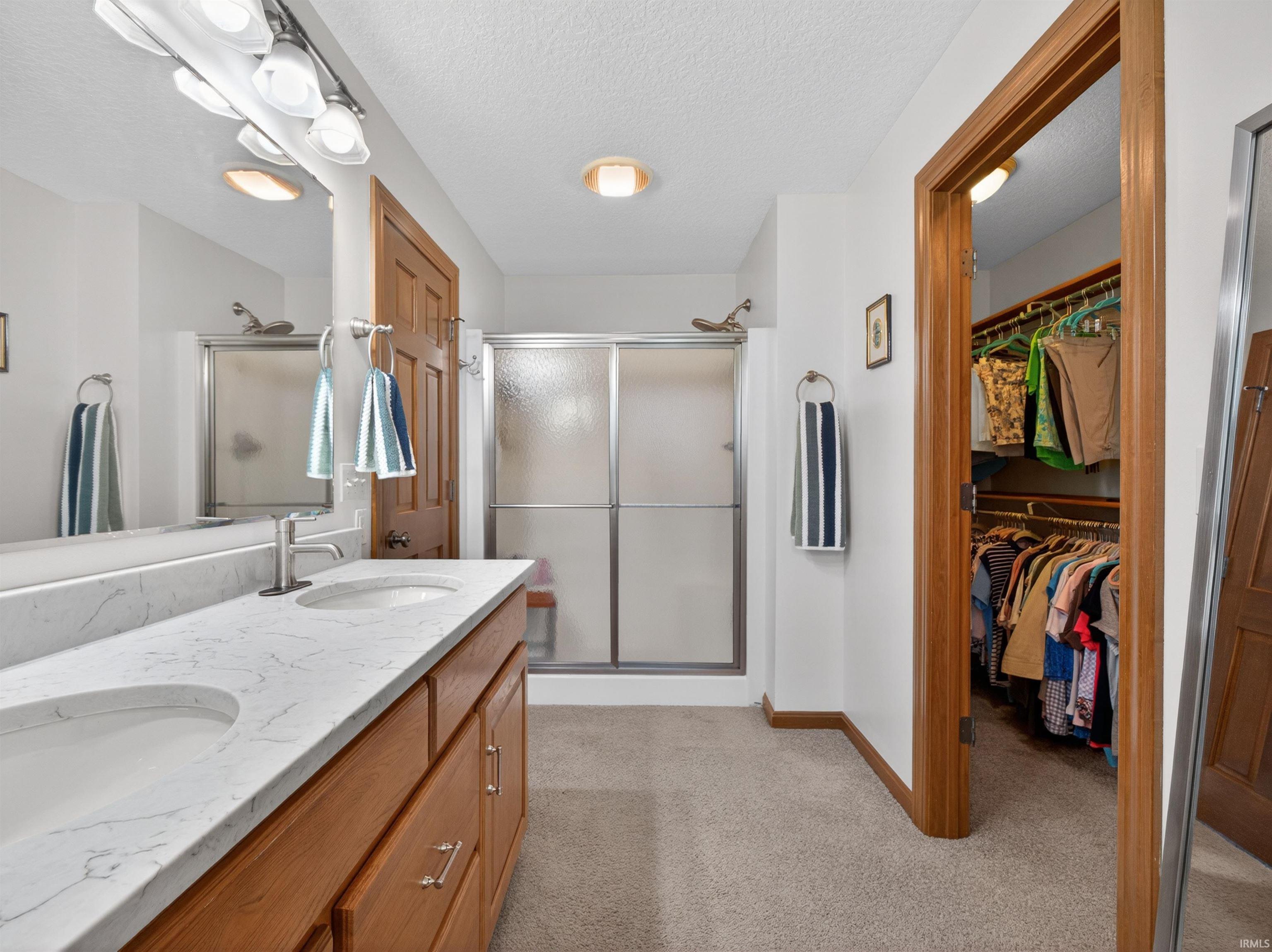 OWNERS SUITE BATHROOM carpeted floor and a shower walkin with a sliding glass door