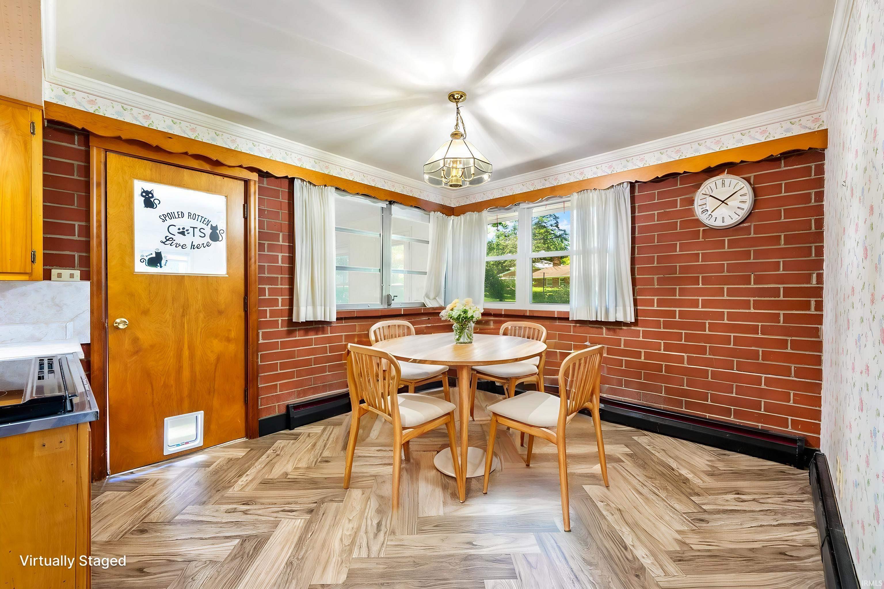 Herringbone wood-finish flooring complements the brick accent walls