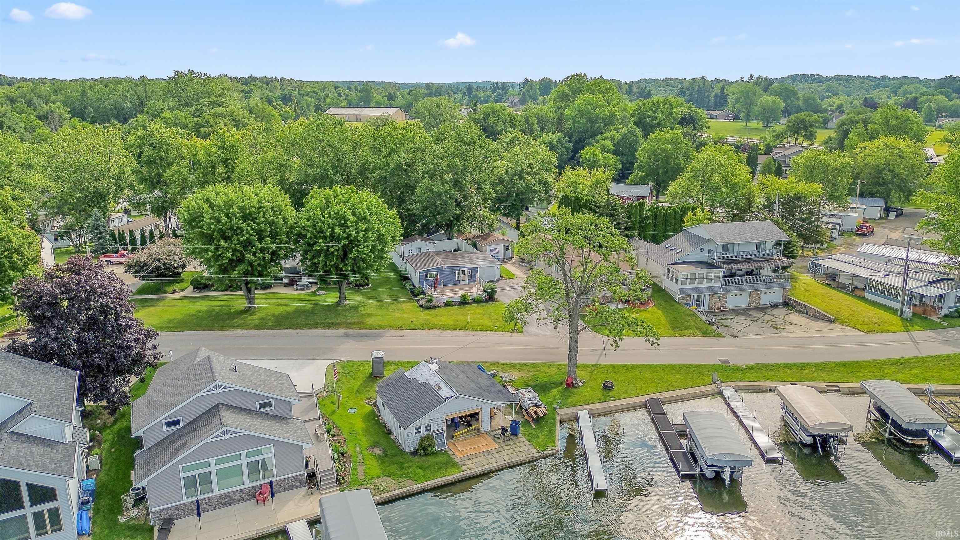 Waterfront property featuring multiple boat slips and a paved driveway