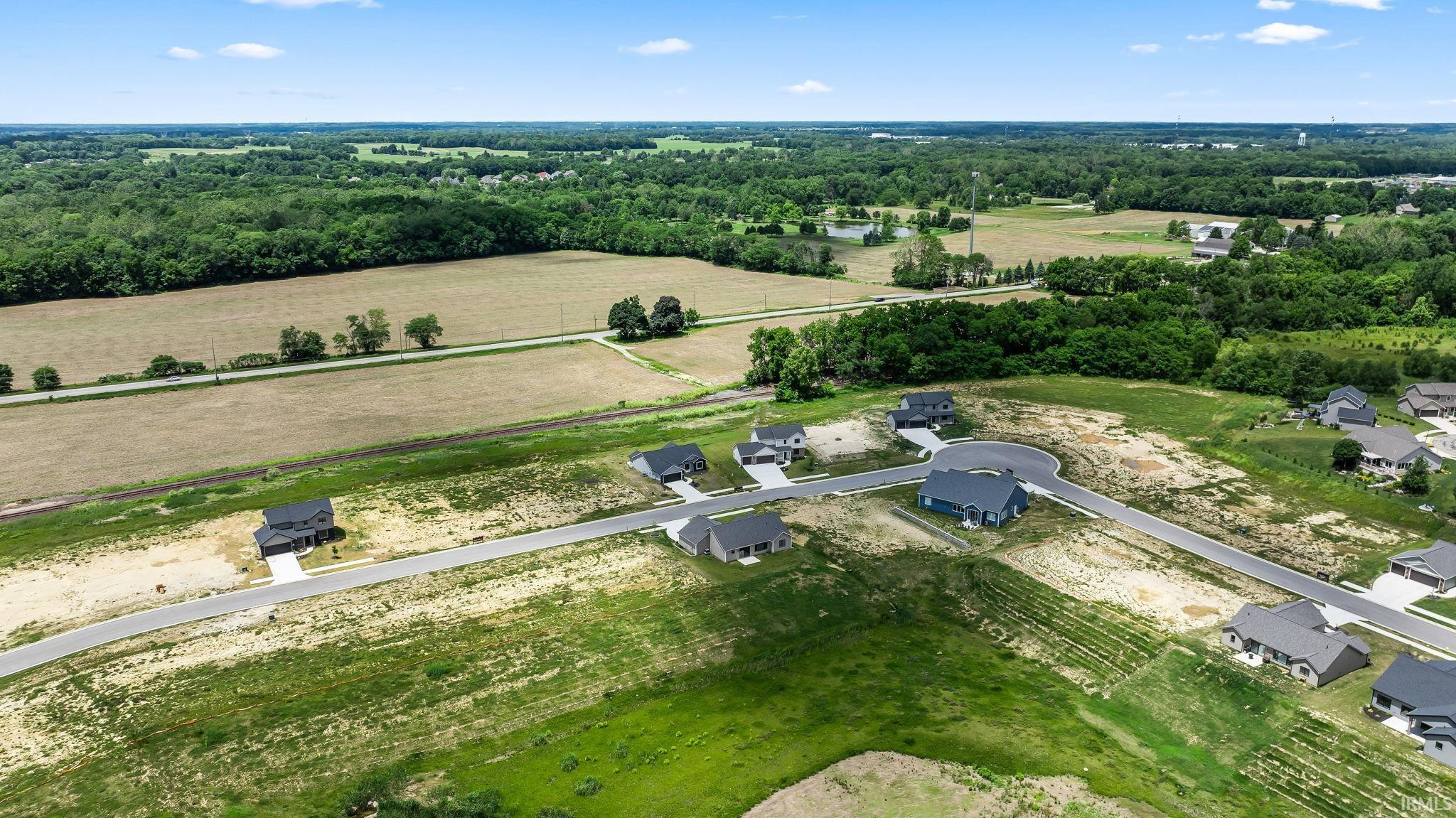Expansive residential development featuring newly constructed homes on spacious lots with paved roadways