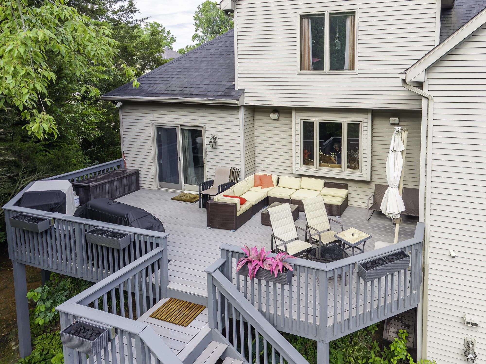 Multi-level deck featuring gray wood-finish flooring and railing
