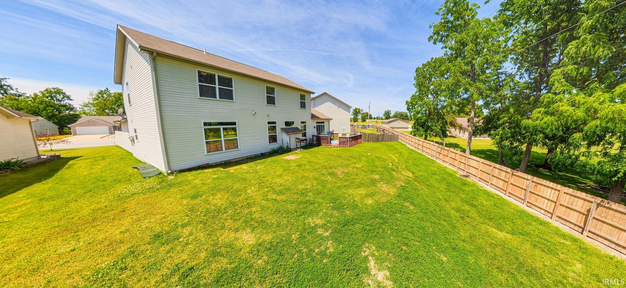 Spacious rear yard with a sloped lawn