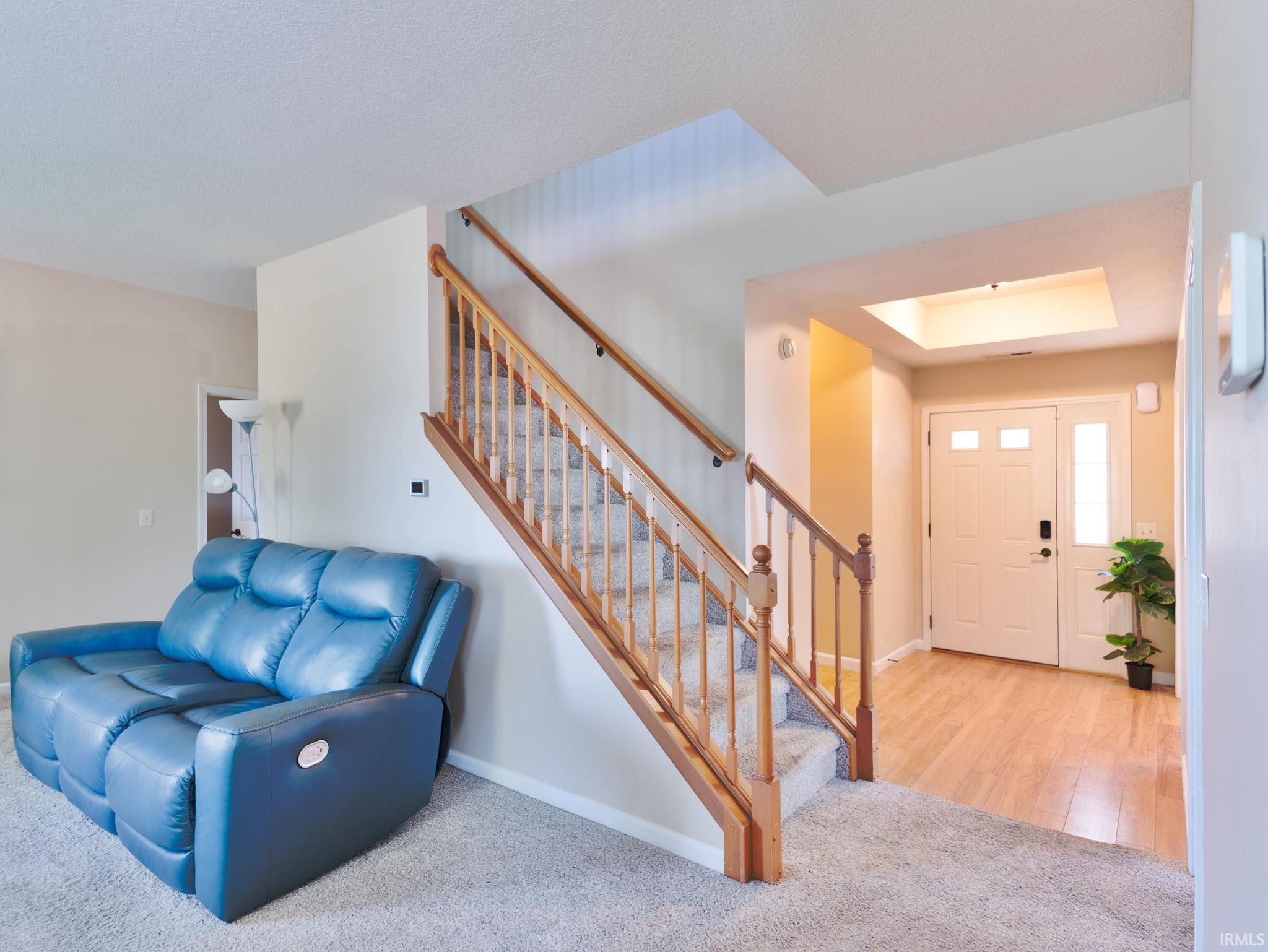 Welcoming entryway featuring wood-finish flooring and a transom window above the door