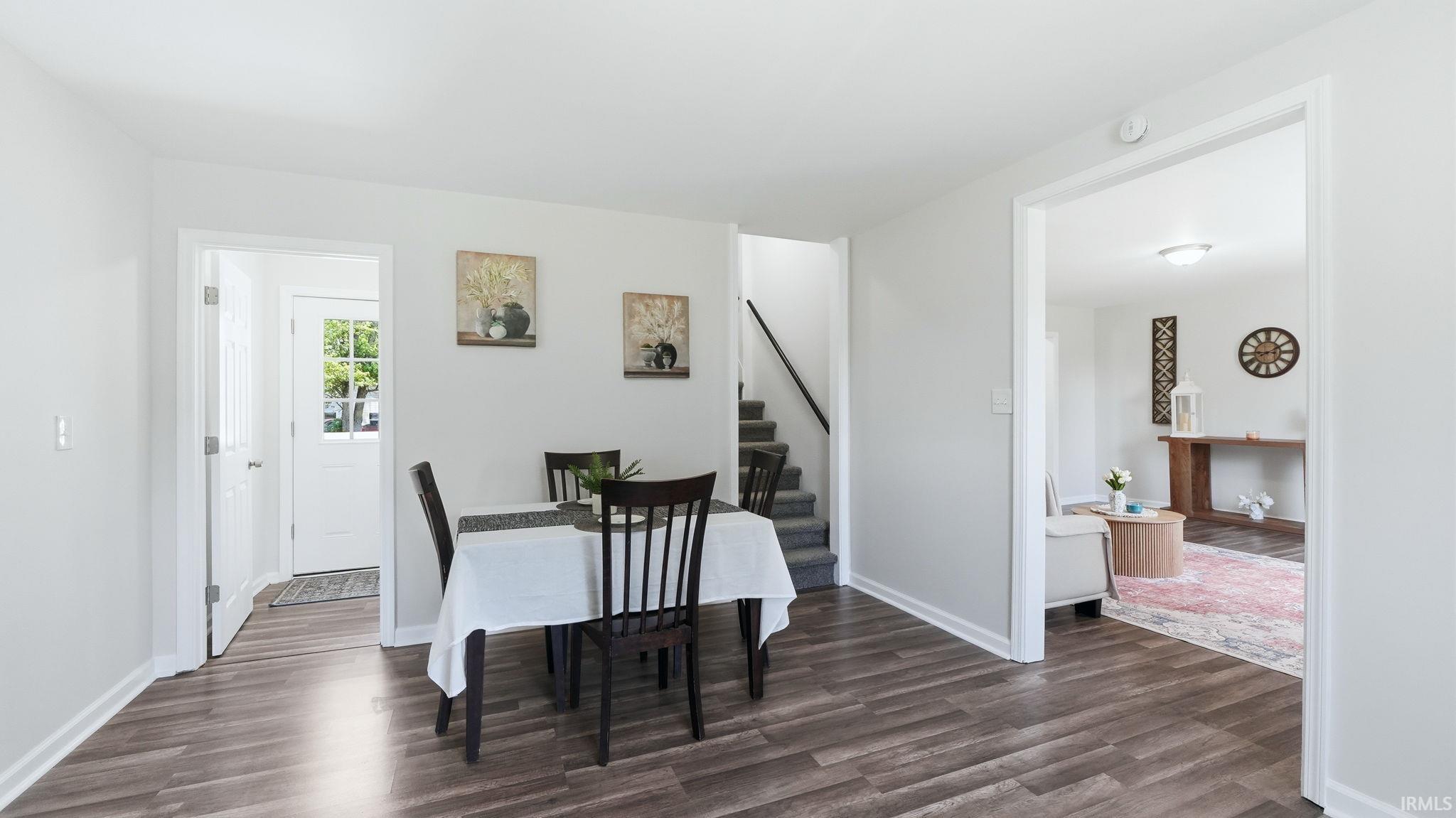 Spacious interior featuring wood-finish flooring, white walls, and bright overhead lighting