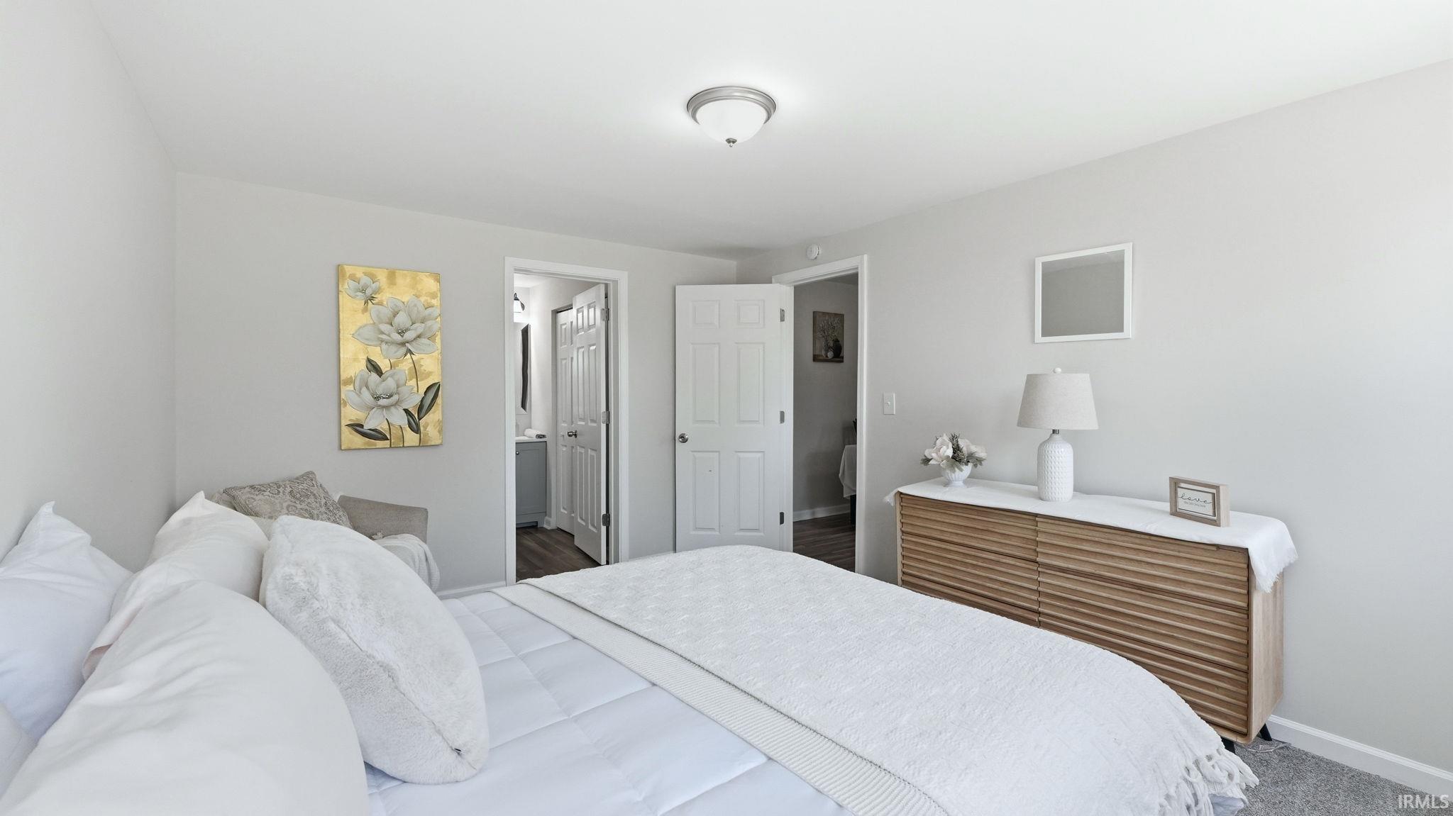 Spacious room with light gray walls and a ceiling-mounted light fixture