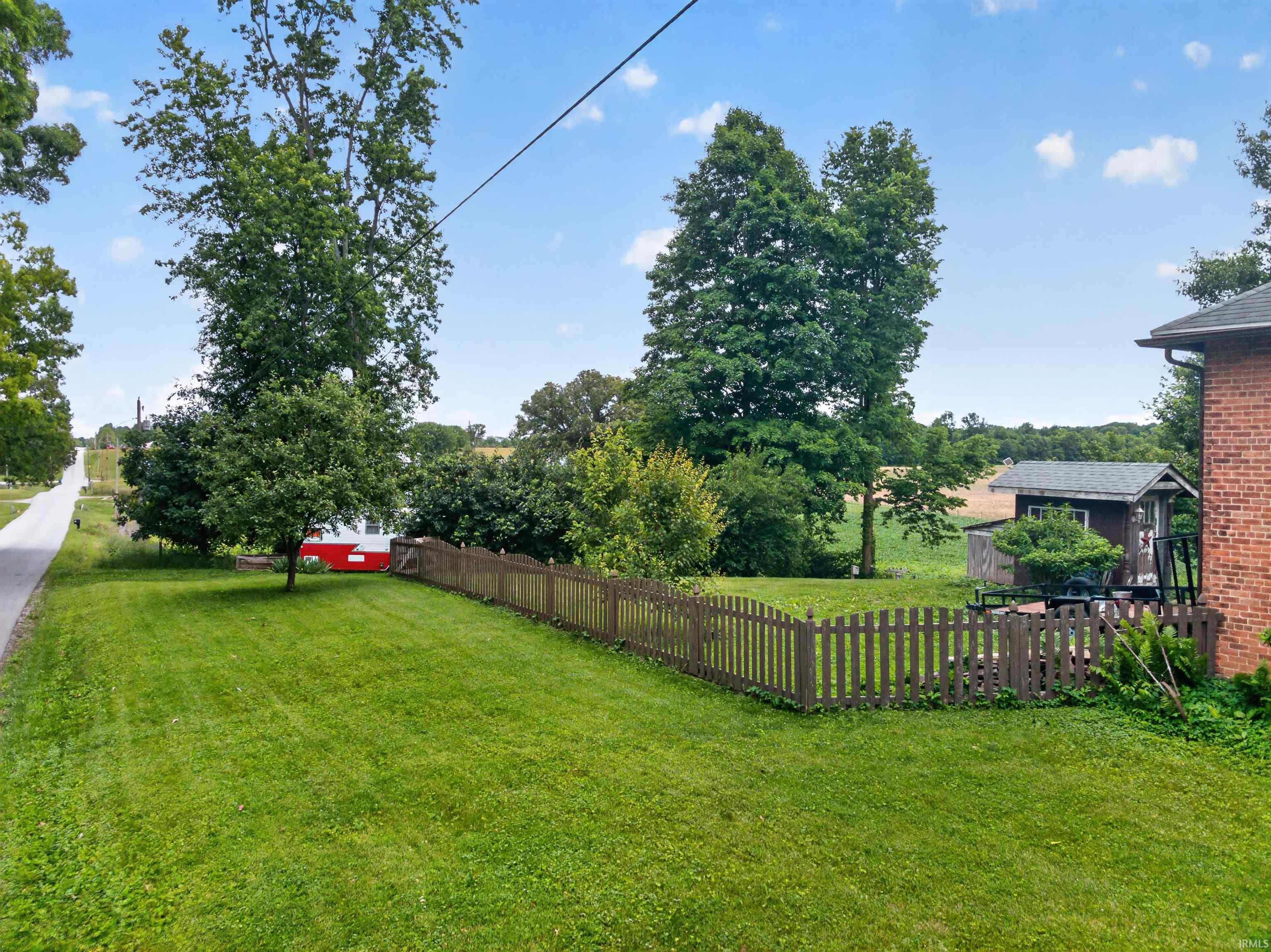 Expansive green lawn bounded by a picket fence