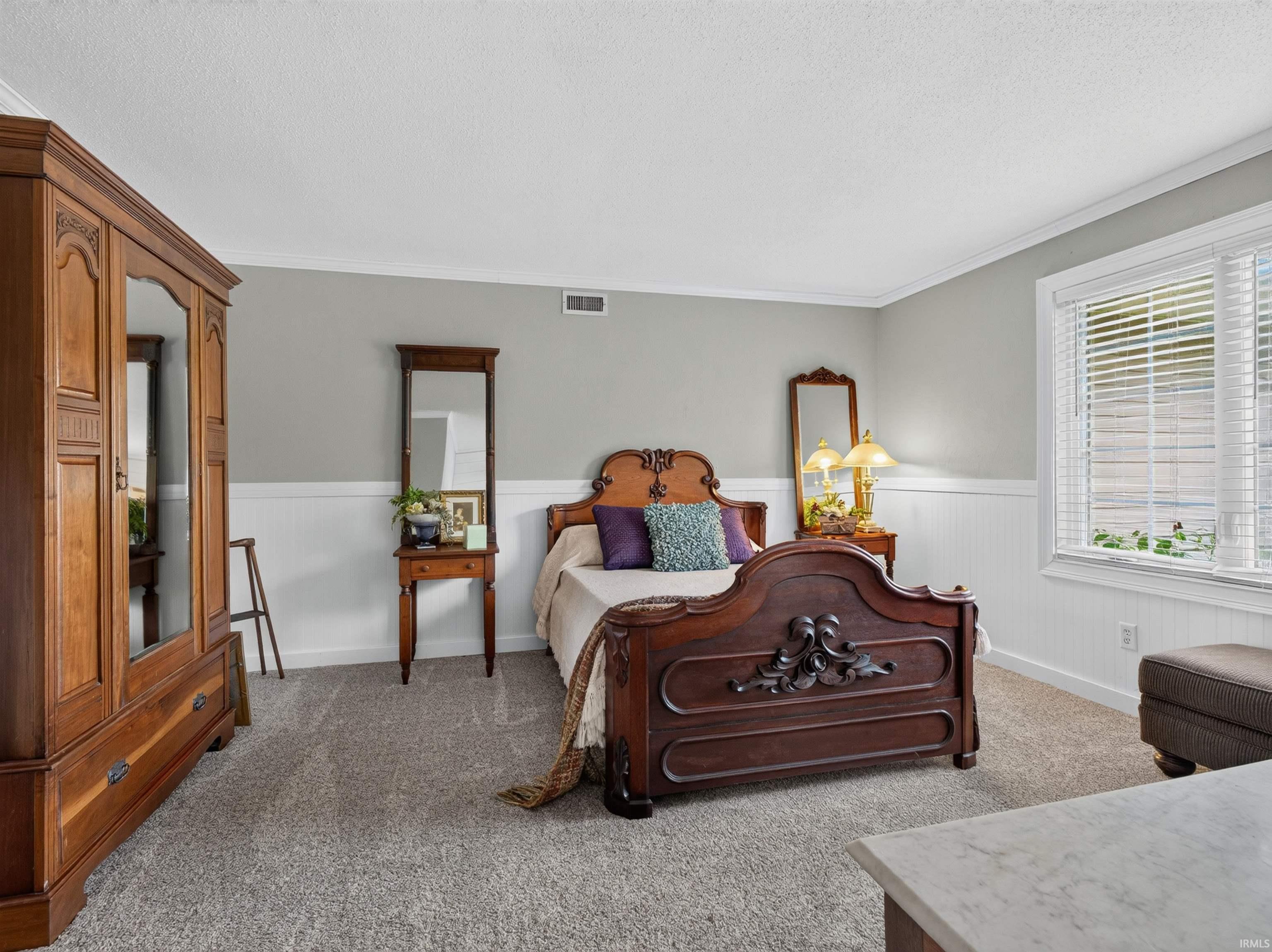 Wall-to-wall carpeting with light gray walls and white wainscoting