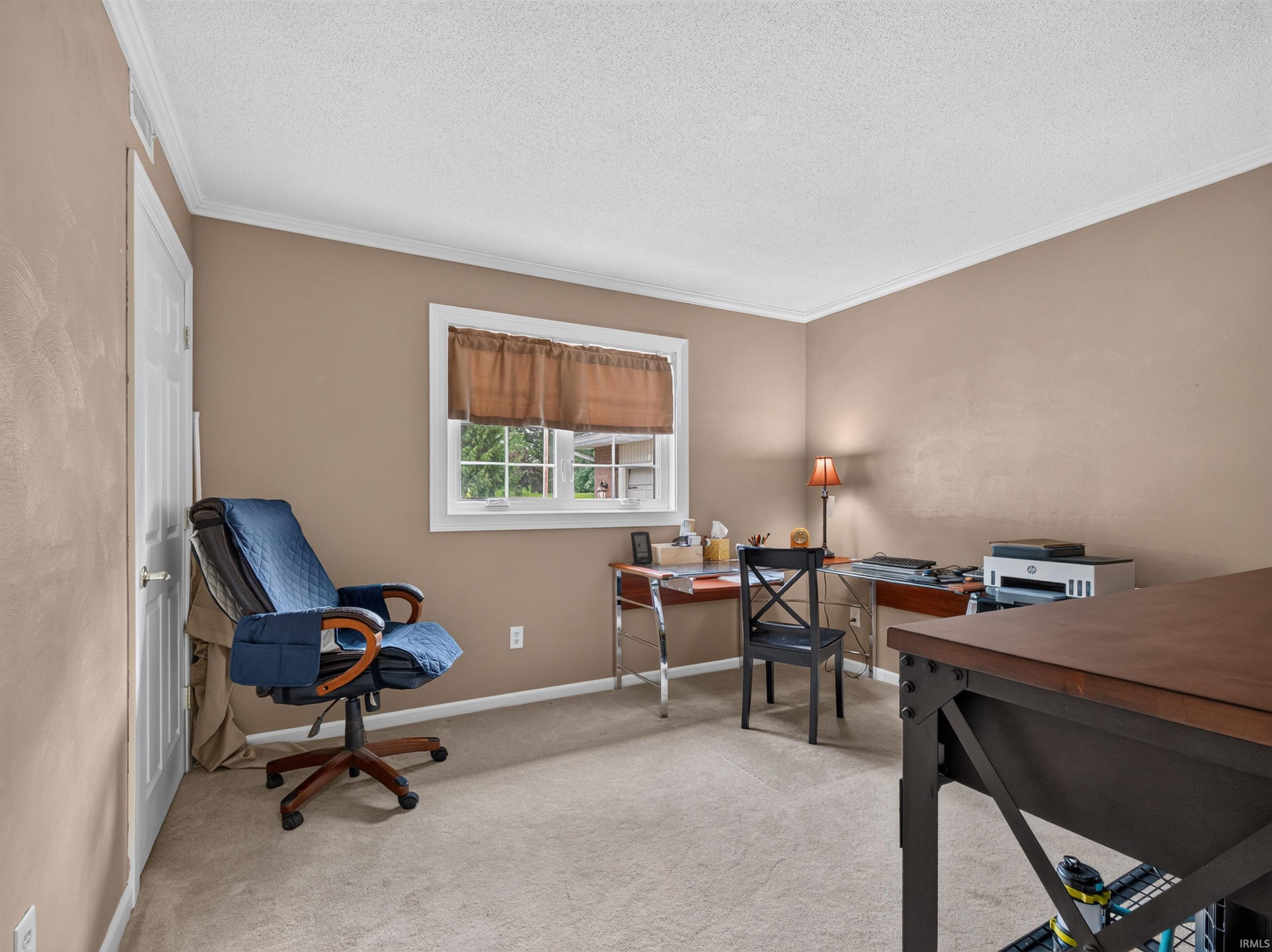 Neutral-toned walls complement the light-colored carpeting