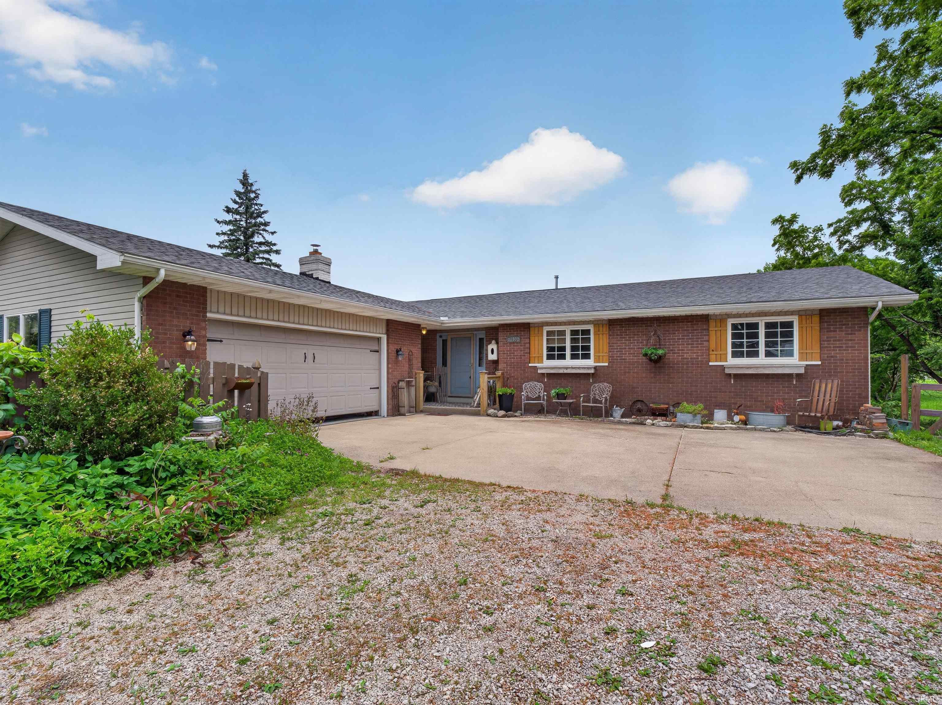 Brick and siding exterior featuring a two-car garage with an overhead door