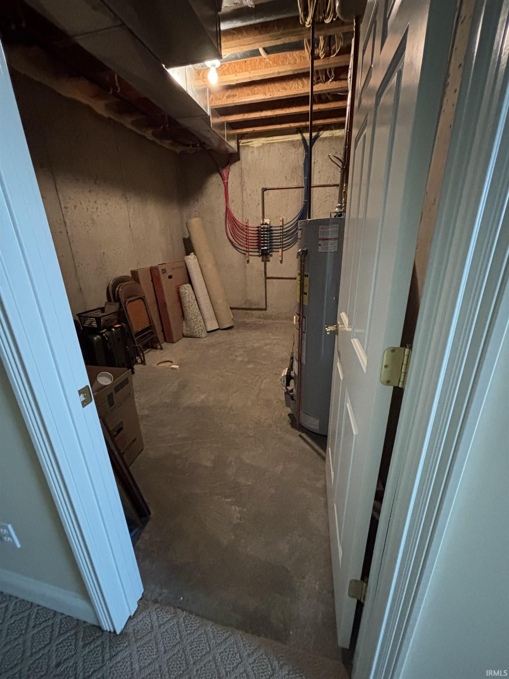 Unfinished basement space with concrete flooring
