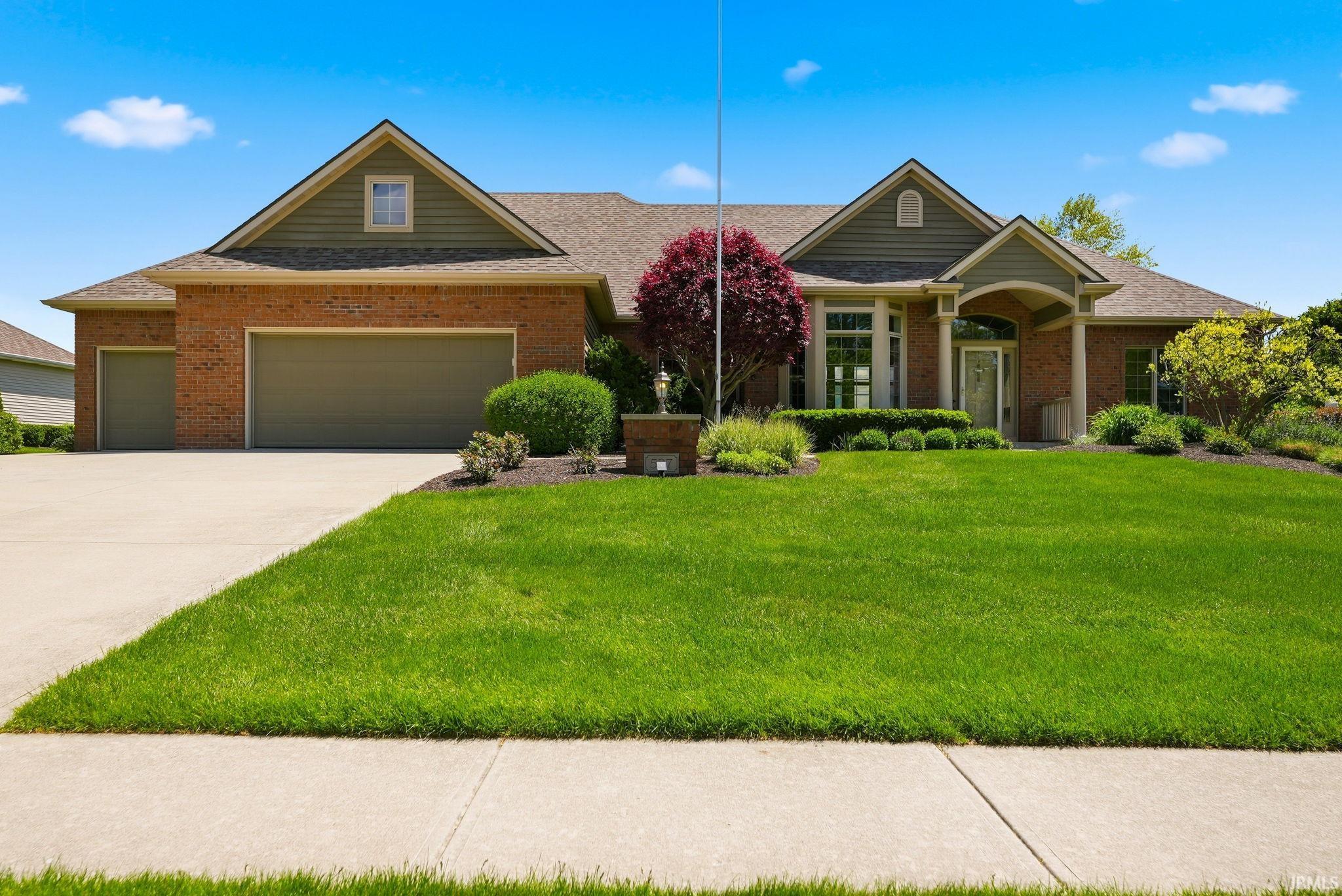 Brick facade residence with a prominent gabled roofline