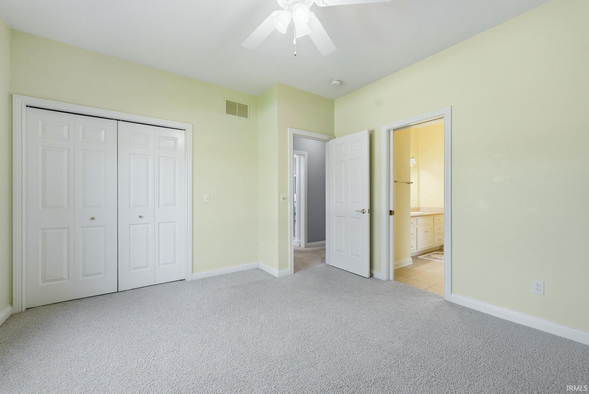Bedroom featuring light-toned walls and plush carpeting