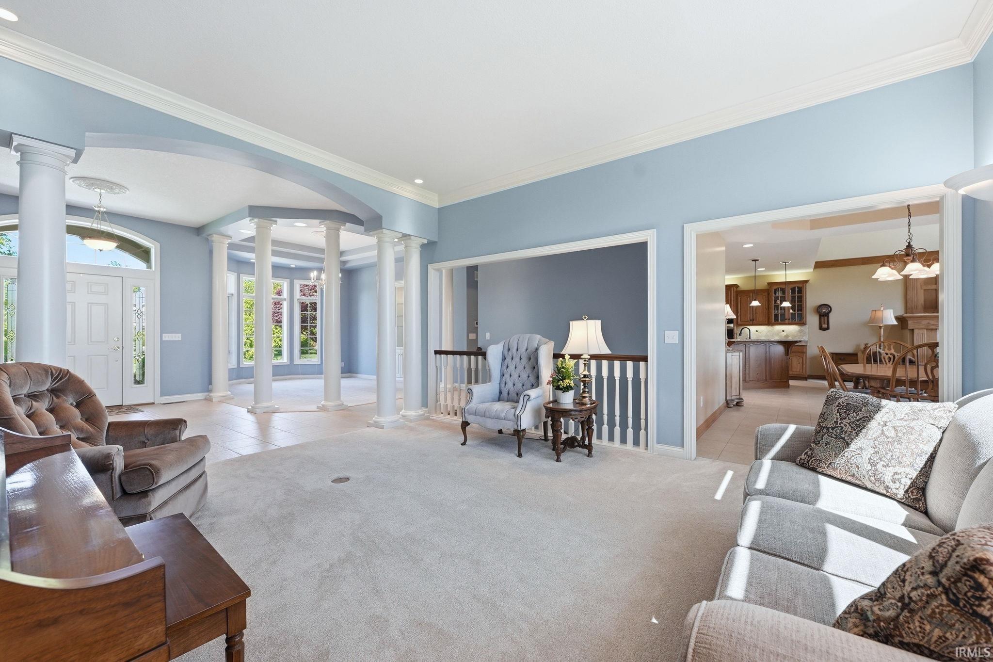 Spacious living area featuring light blue walls and plush carpeting