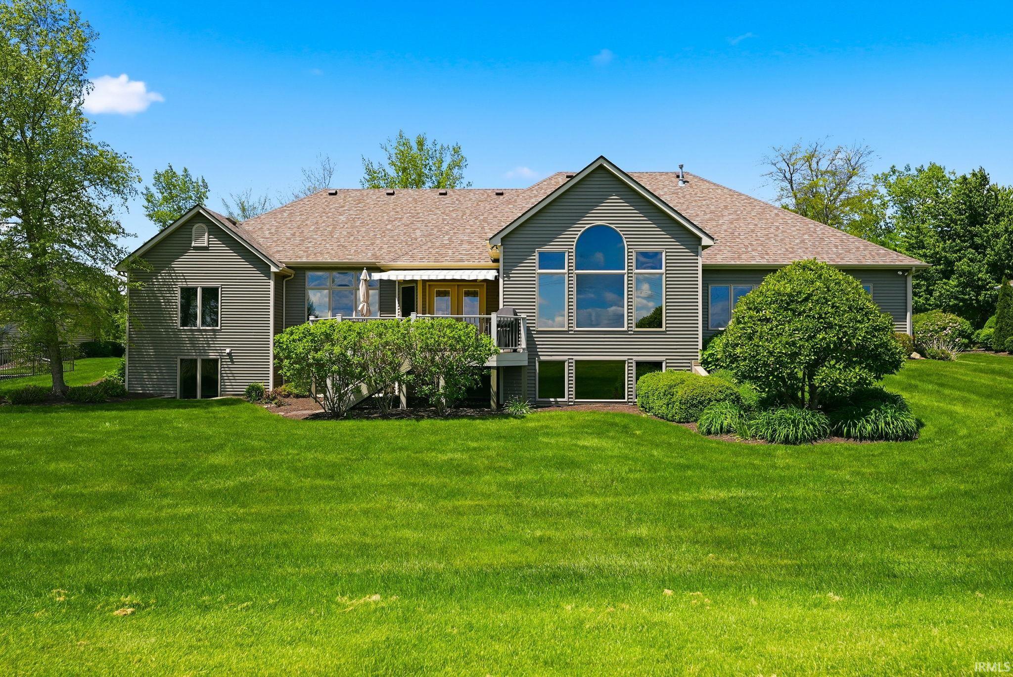 Expansive green lawn with mature landscaping