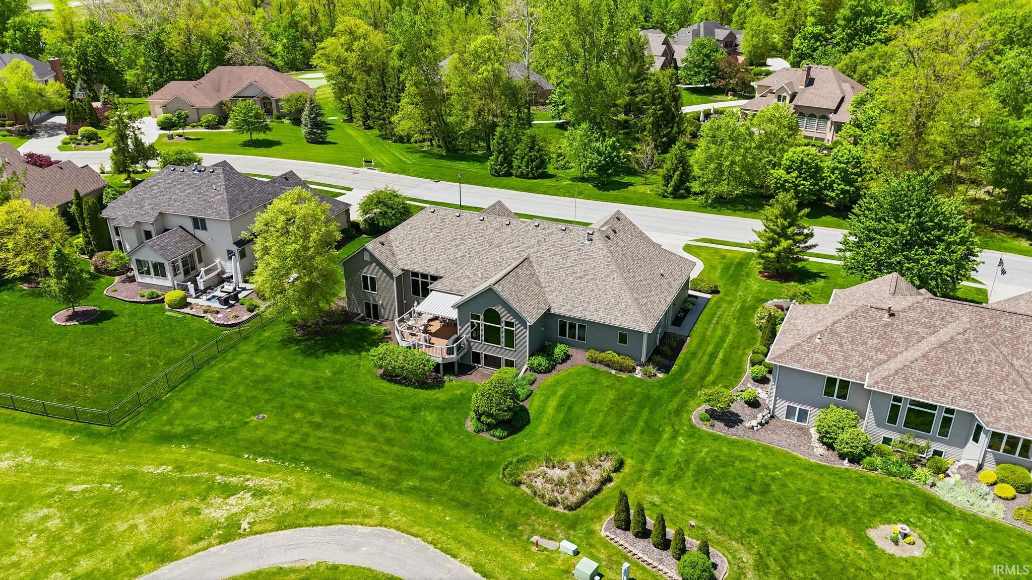 Expansive landscaped grounds featuring mature trees and established plantings