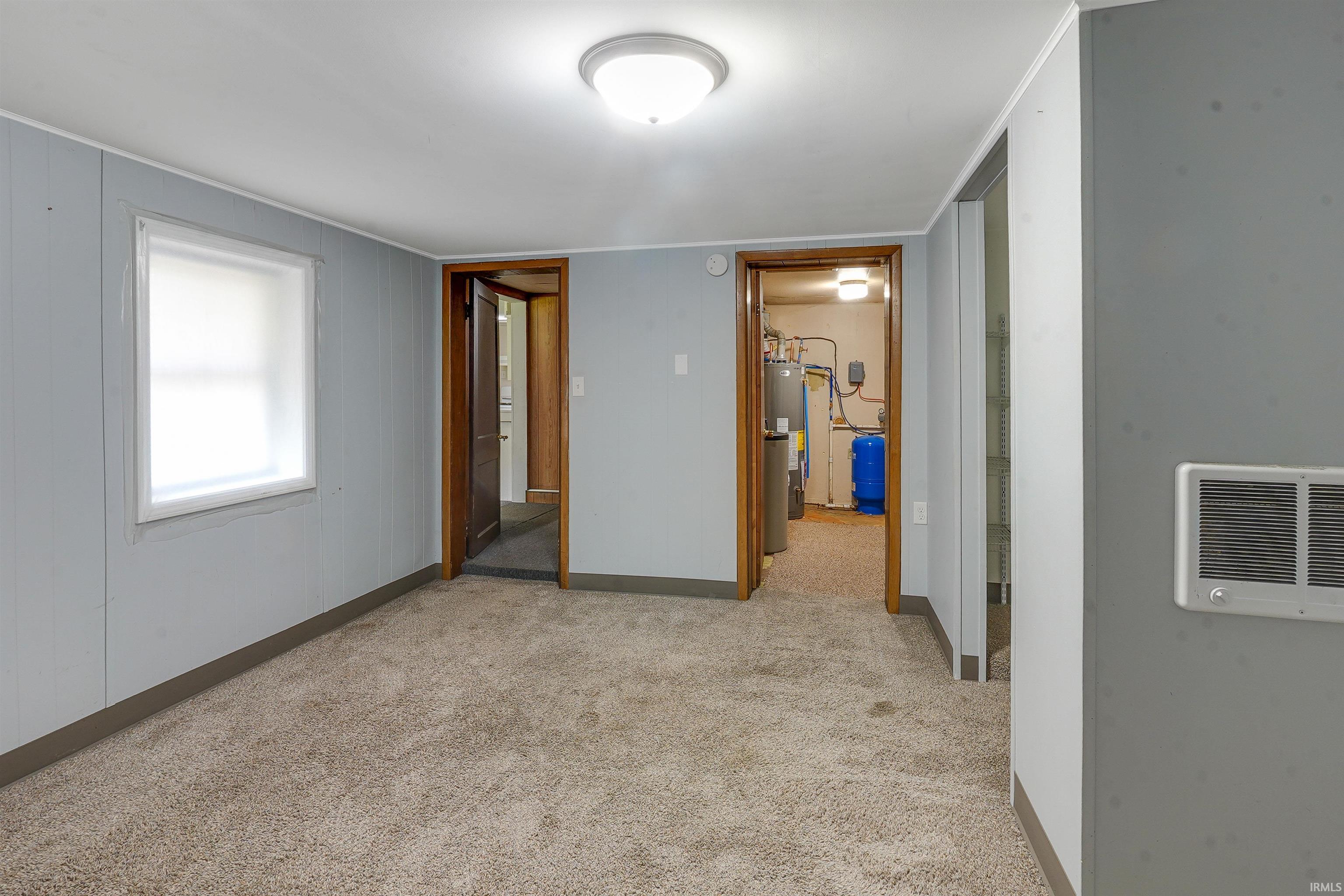 Carpeted room with light blue walls and white trim
