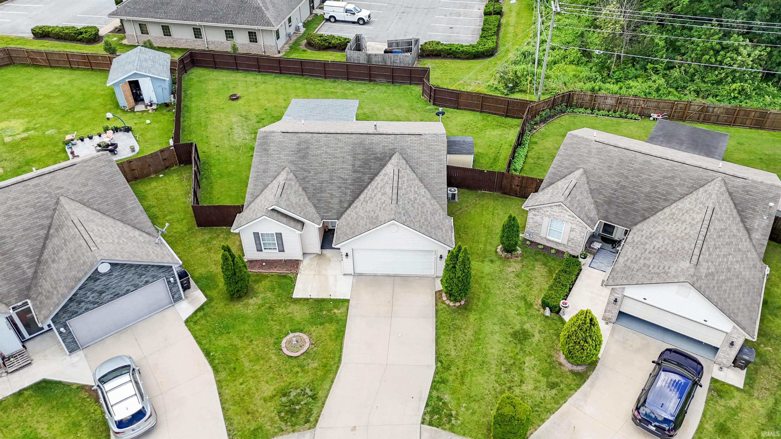 Single-family home featuring a two-car garage, concrete driveway, and established landscaping