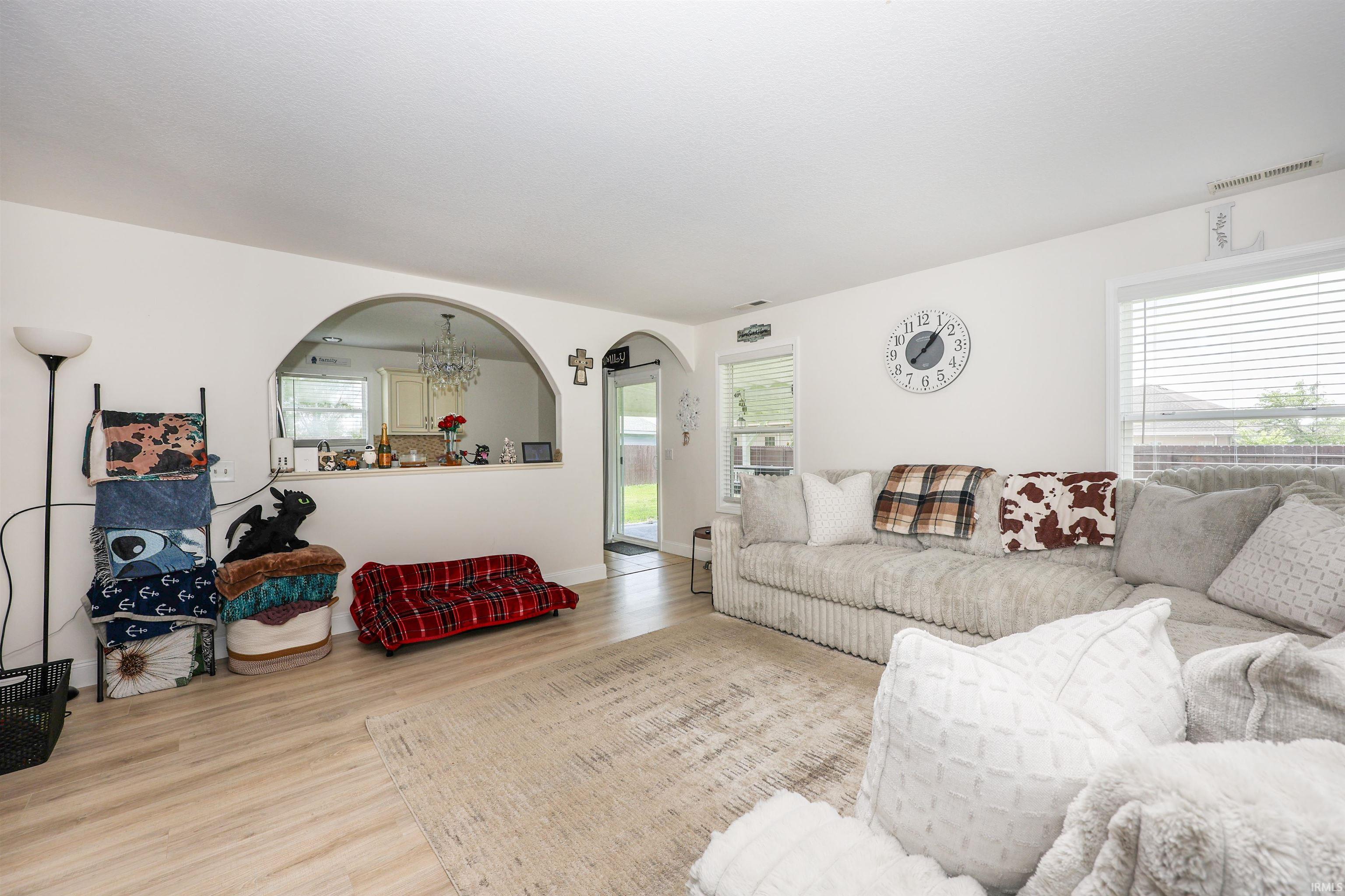 Living area featuring light wood-finish flooring and neutral wall tones
