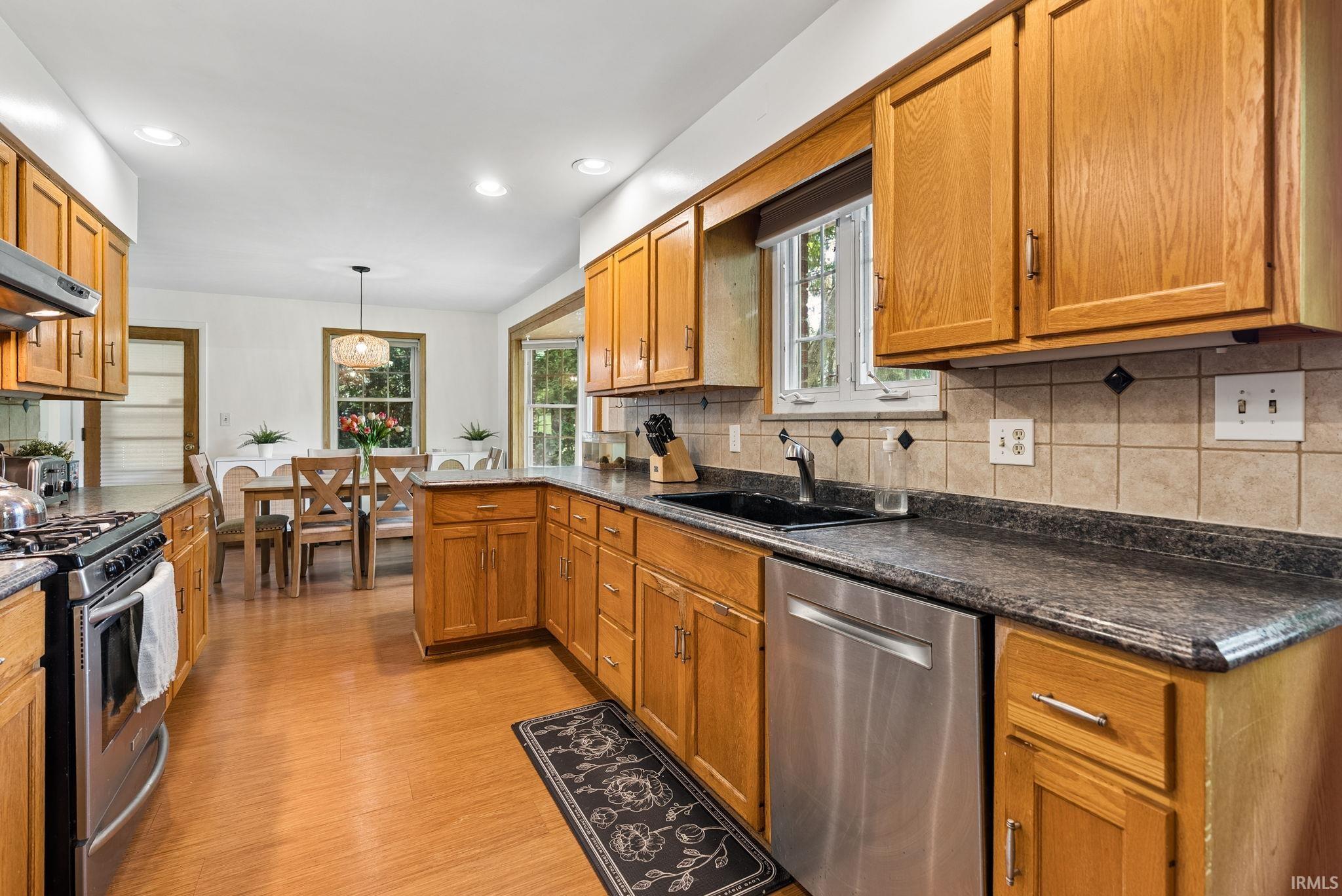 Kitchen featuring wood-finish flooring, recessed lighting, and ample cabinetry