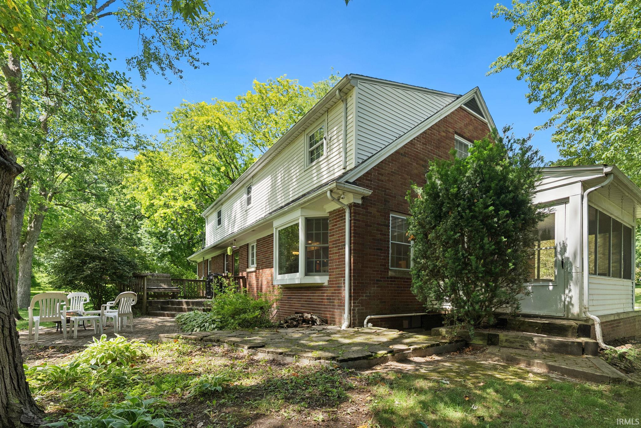 Two-story residence featuring a brick and white siding exterior