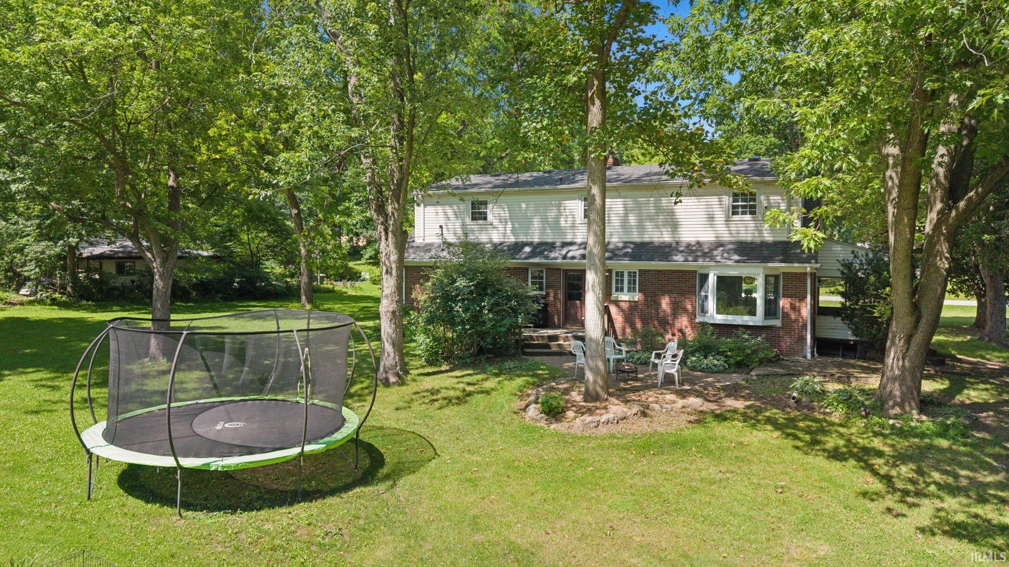 Brick and siding exterior featuring a multi-pane bay window