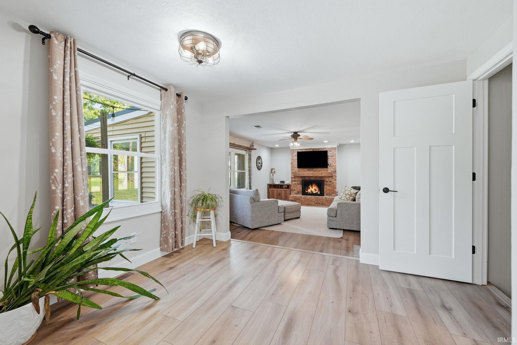 Light wood-finish flooring with a modern three-panel interior door