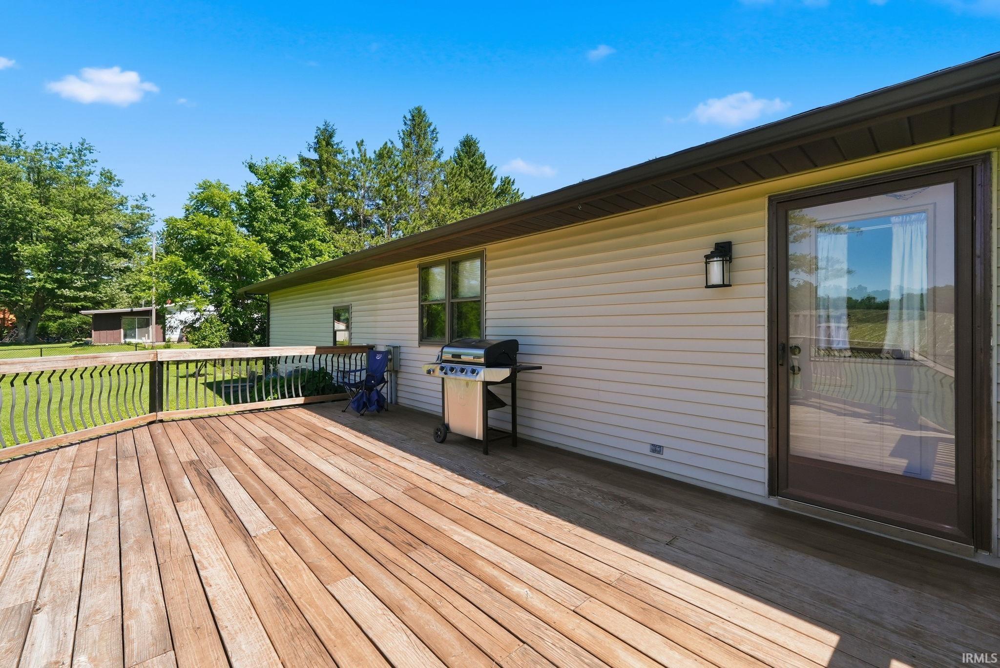 Spacious wood deck with a decorative railing, providing ample outdoor living space