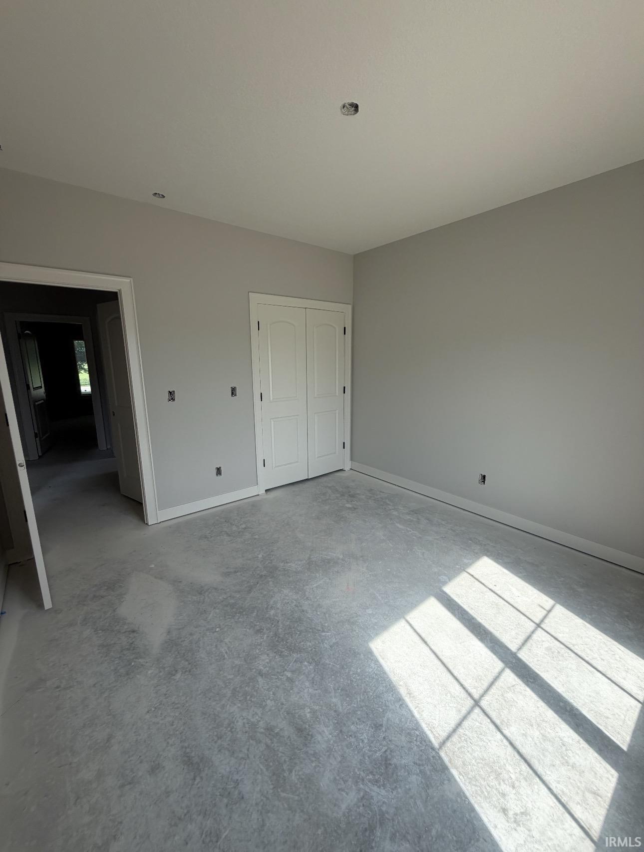 Unfinished concrete flooring with light gray painted walls