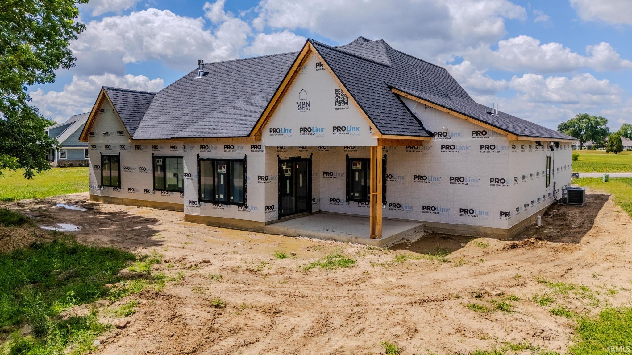 New construction residence featuring a dark shingle roof and multiple gables